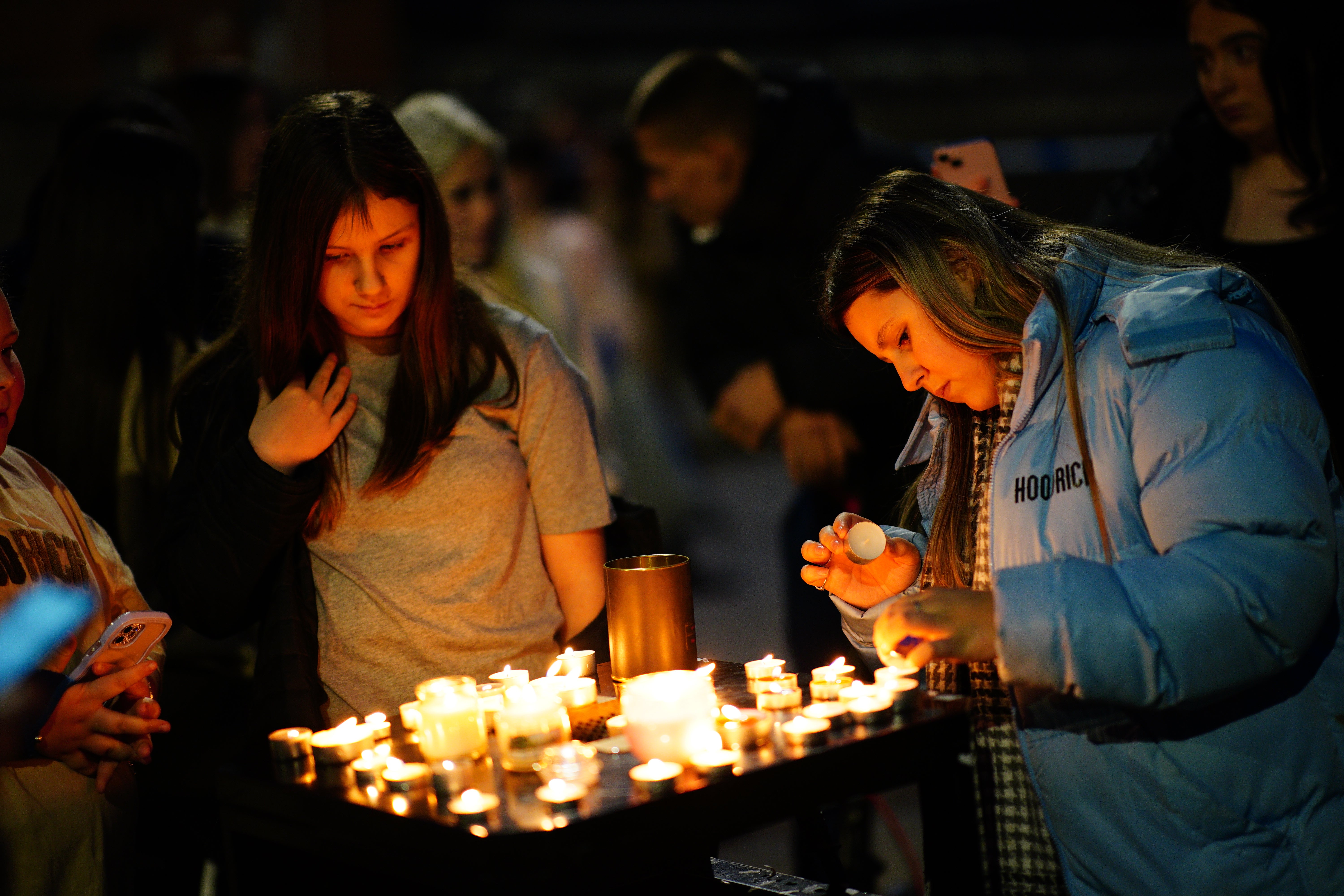 People take part in a vigil near to the scene in south Bristol