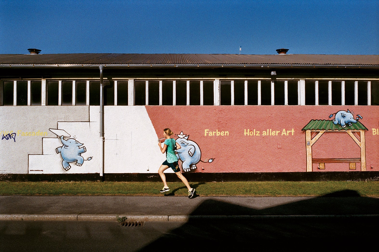 A young woman jogs past a building materials supplier near Rostock