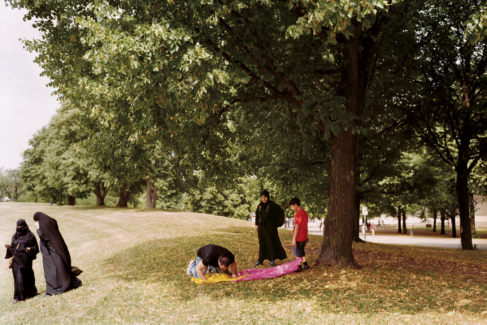 A man prays in a park in Munich