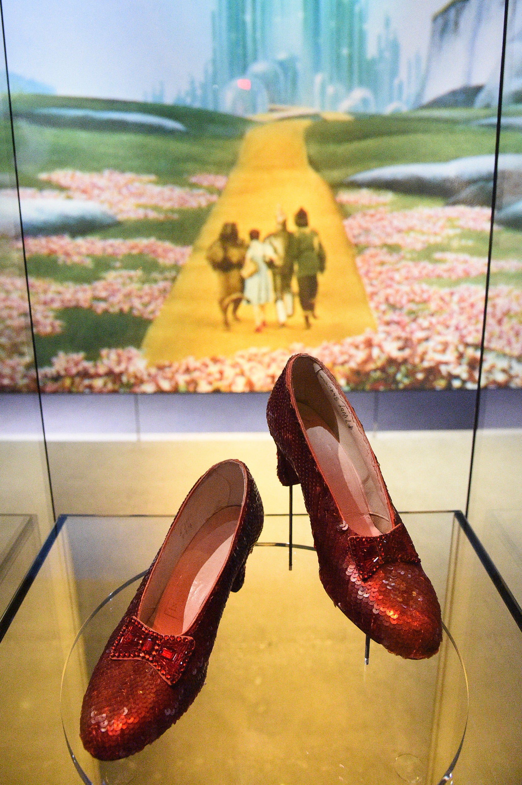 A pair of ruby slippers worn by Judy Garland in the Wizard of Oz on display at the Academy Museum in 2021