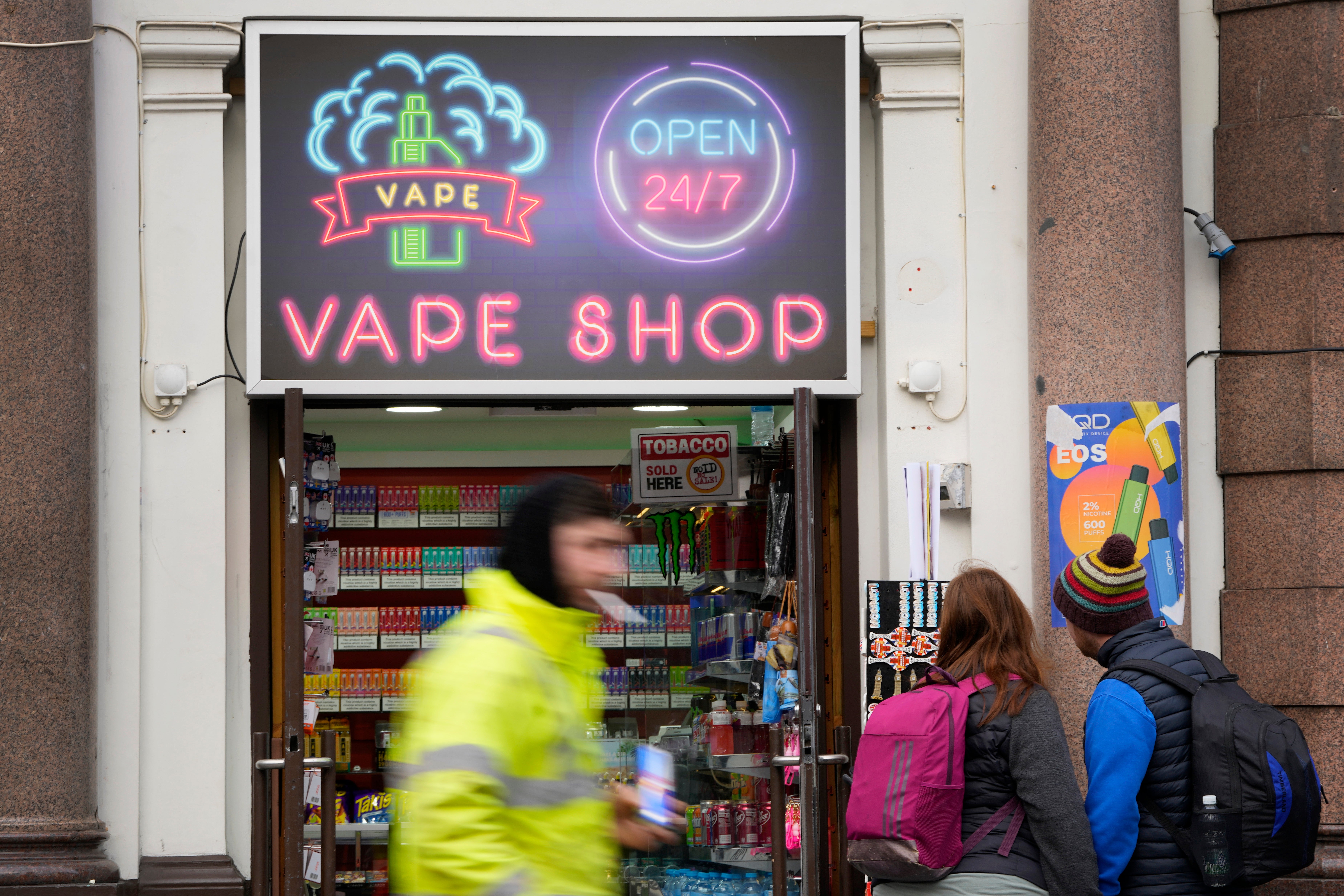 Pedestrians pass a vape shop in London, Monday, January 29, 2024