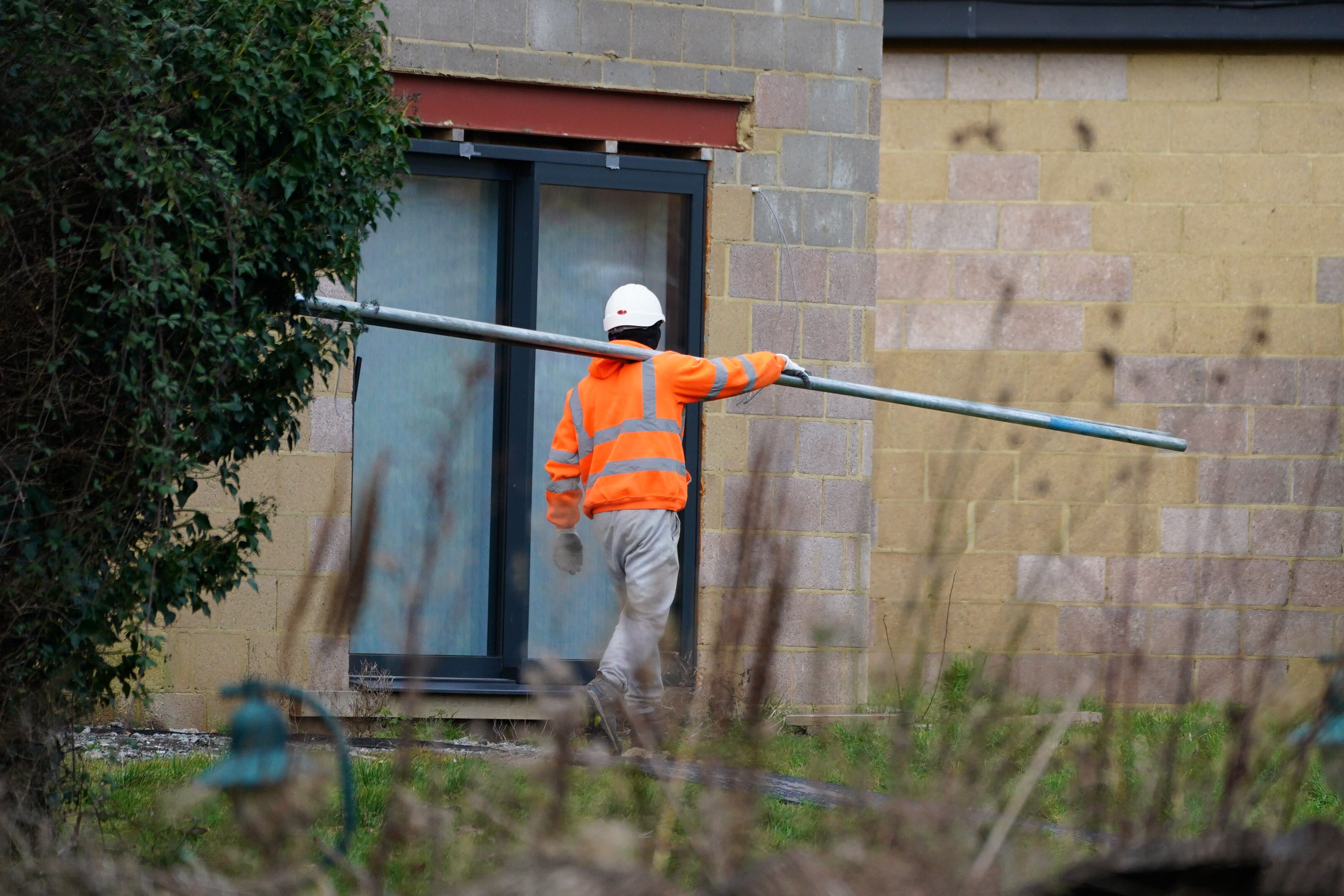 Scaffolders work at the unauthorised spa pool block at the home of Captain Sir Tom Moore’s daughter Hannah Ingram-Moore