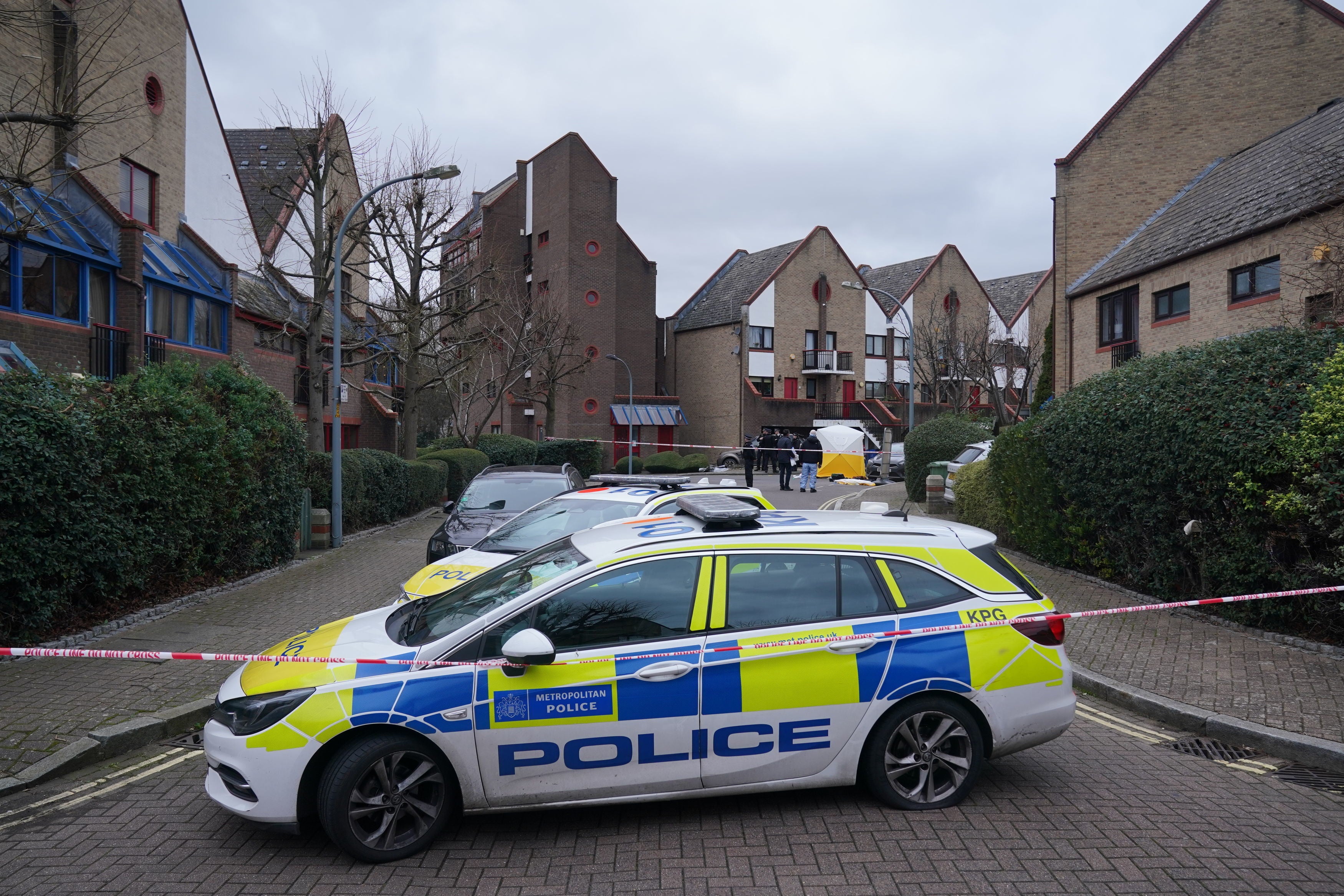 Police and forensics officers work at the scene of the shooting