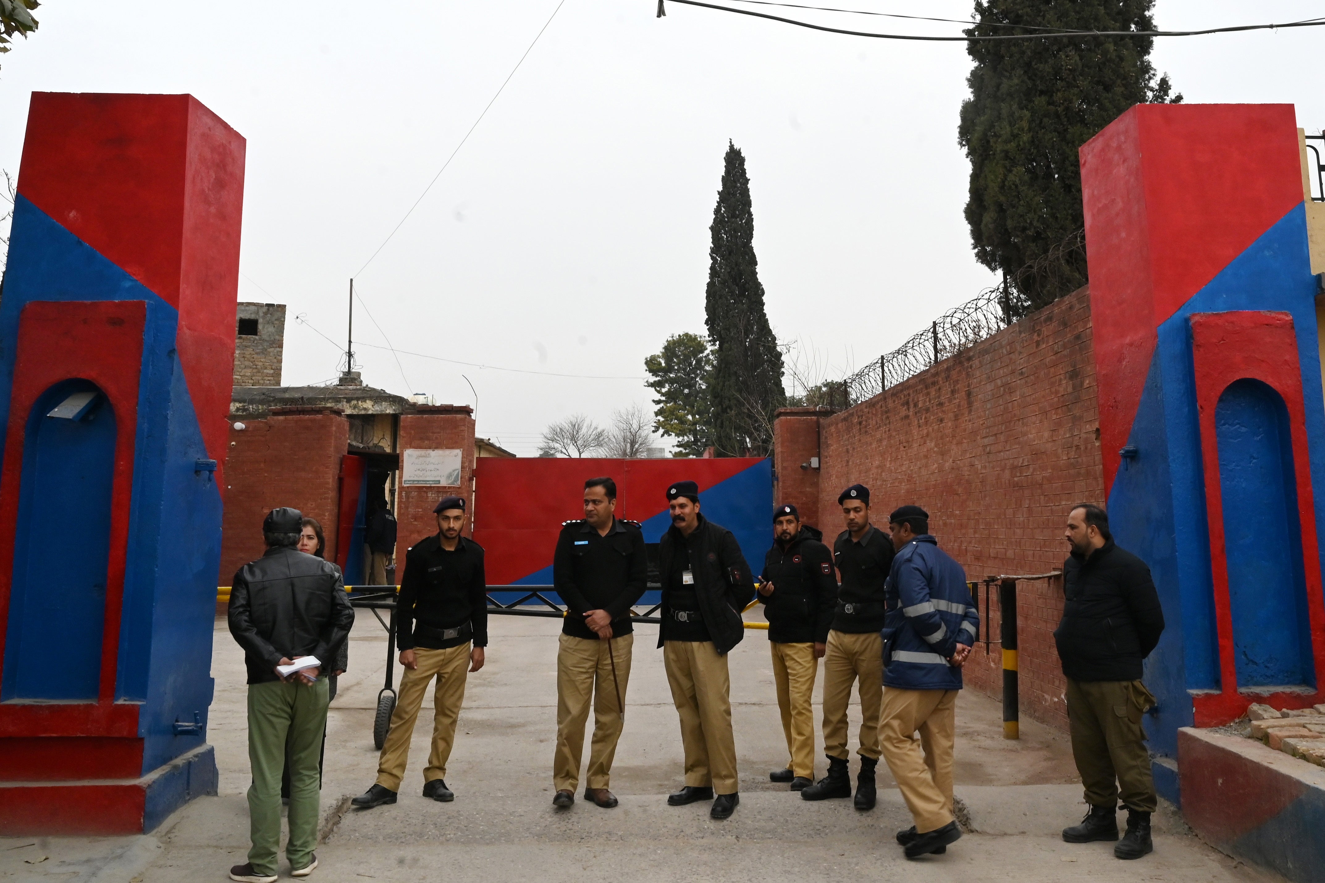 Police personnel stand outside the entrance of Adiala Jail during the hearing of jailed former Pakistan's Prime Minister Imran Khan, in Rawalpindi