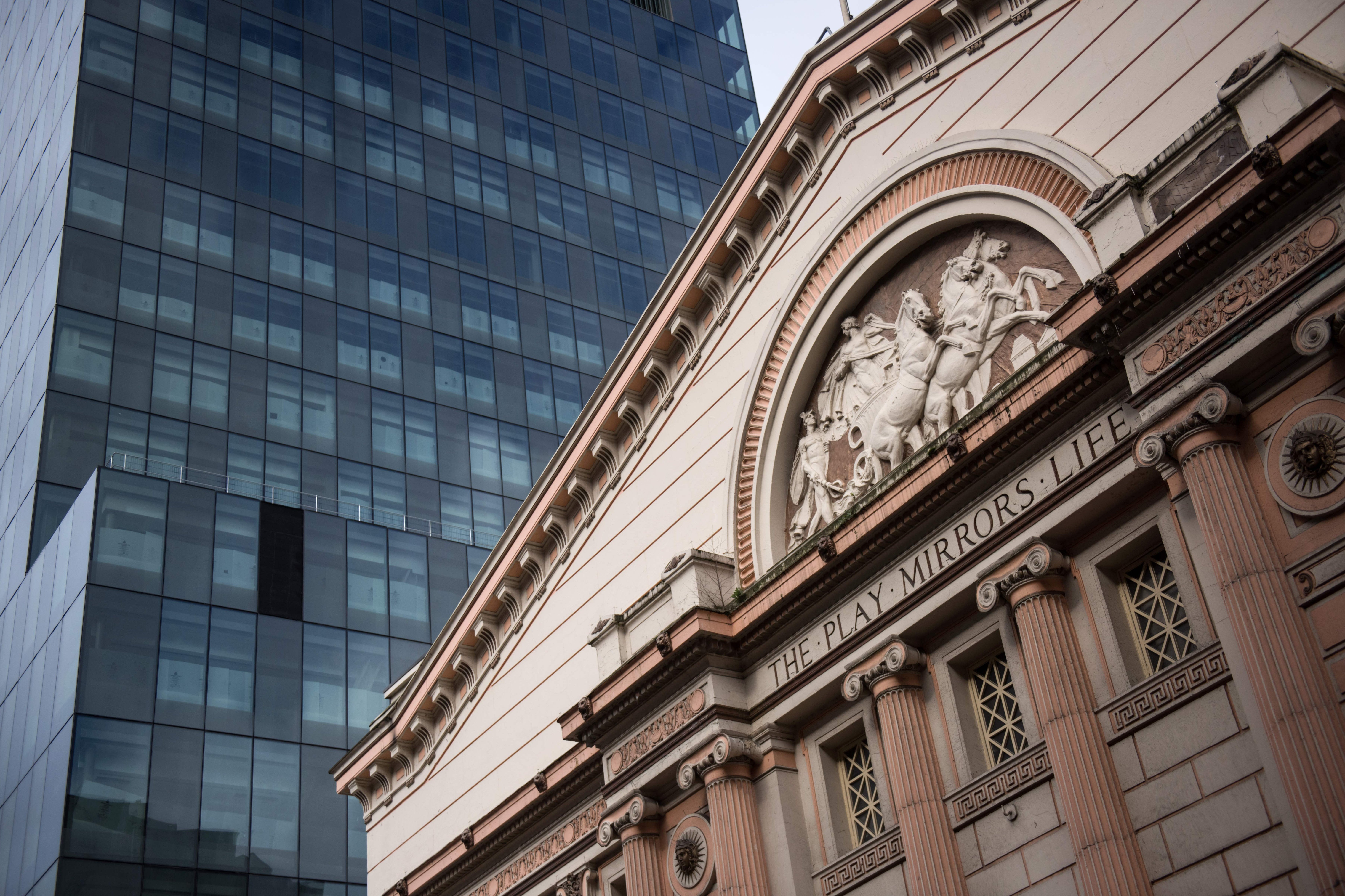 Manchester Opera House is pictured next to to a skyscraper under construction