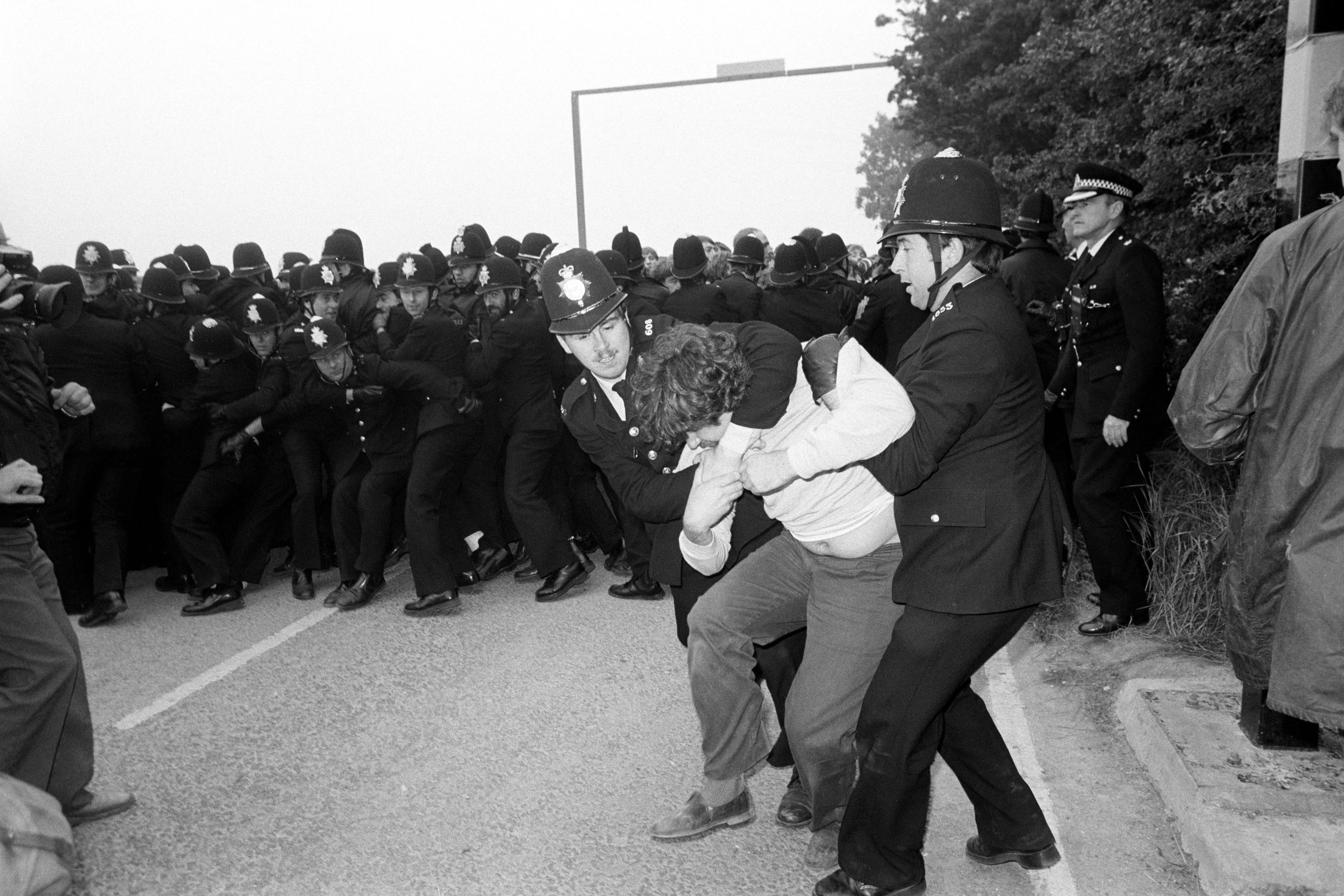 Police grapple with a picketing miner in August 1984