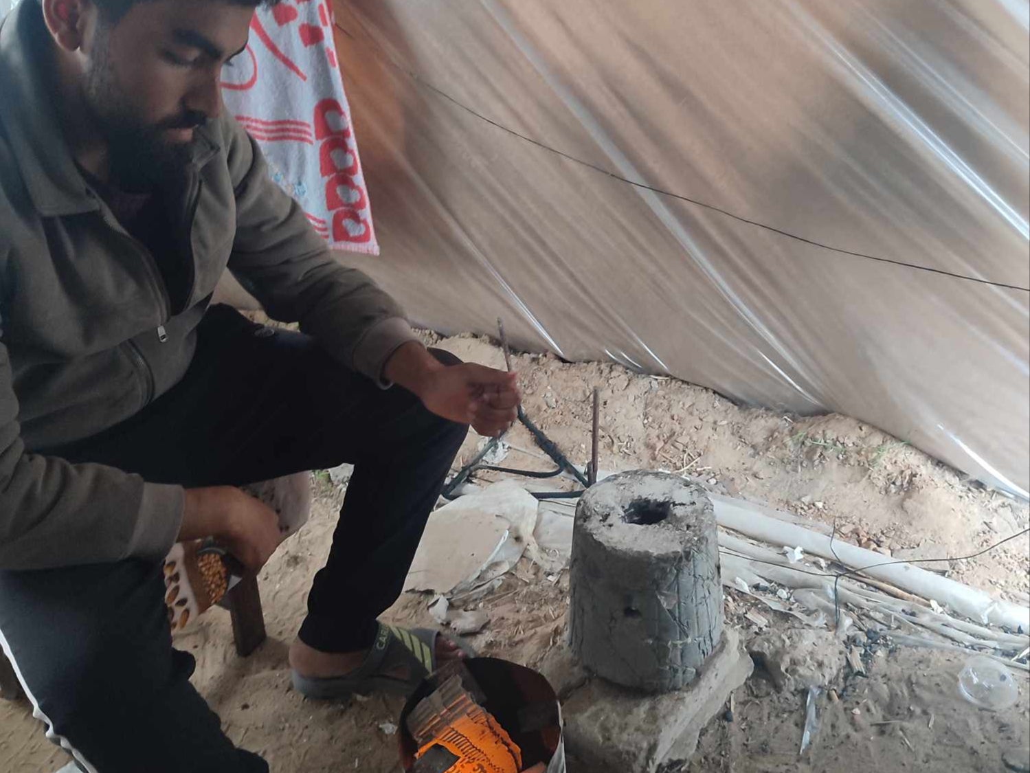 There is no electricity, so any food the family can find it cooked using this small fire