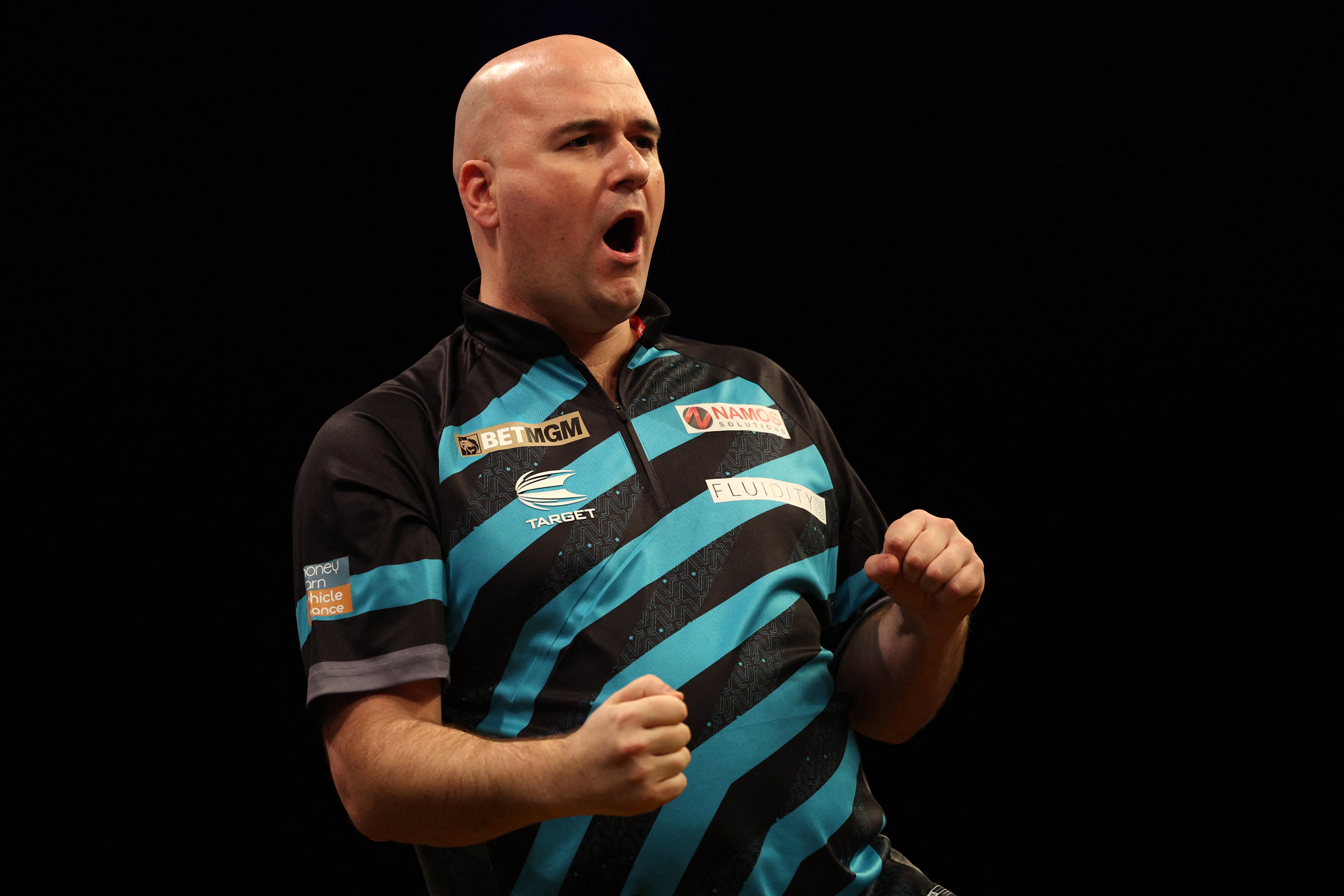 Rob Cross celebrates after securing victory