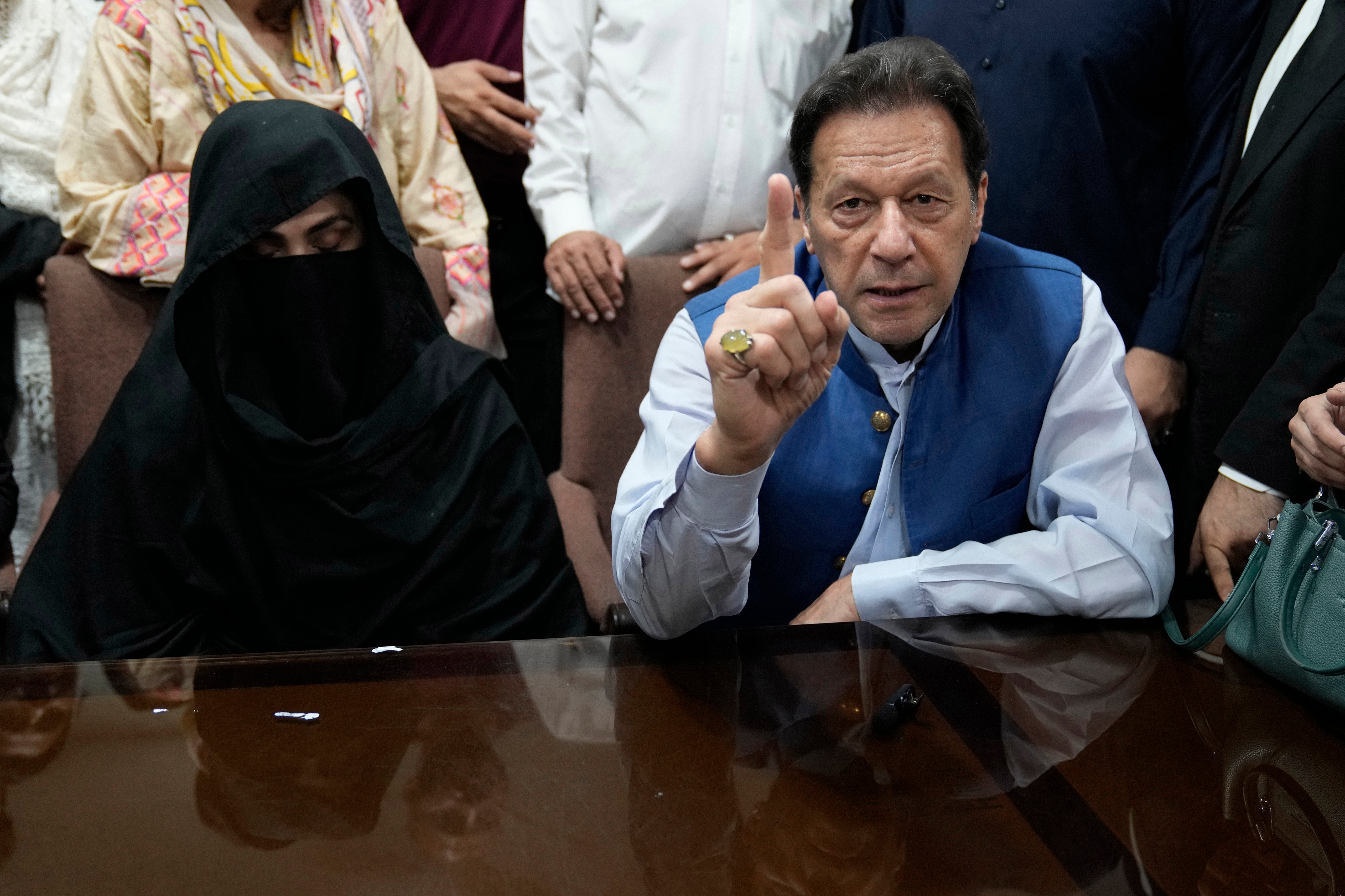 Imran Khan and wife Bushra Bibi speak to the media in Lahore last July