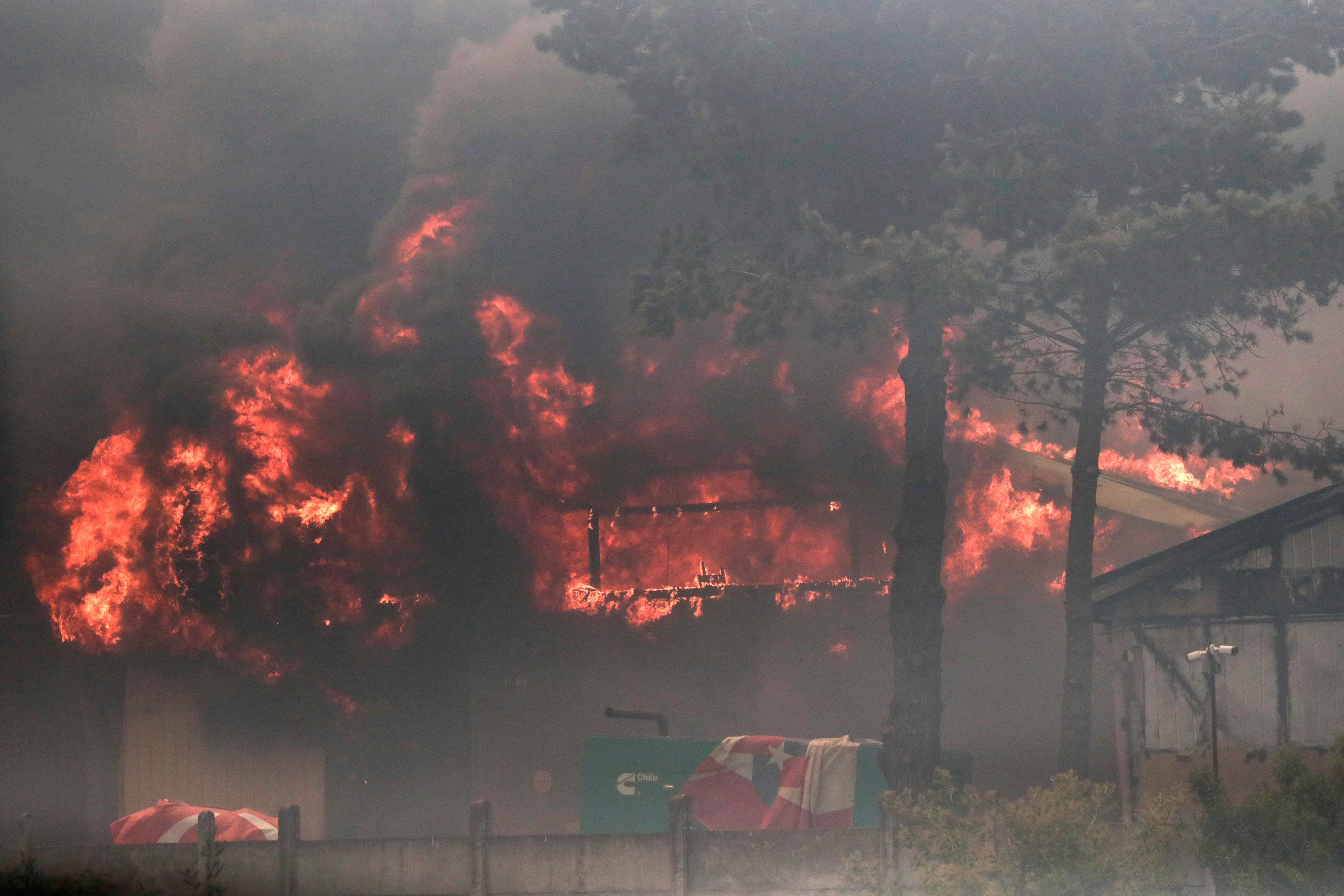 A fire burns a building in an industrial area during the forest fires affecting Vina del Mar, Valparaiso Region