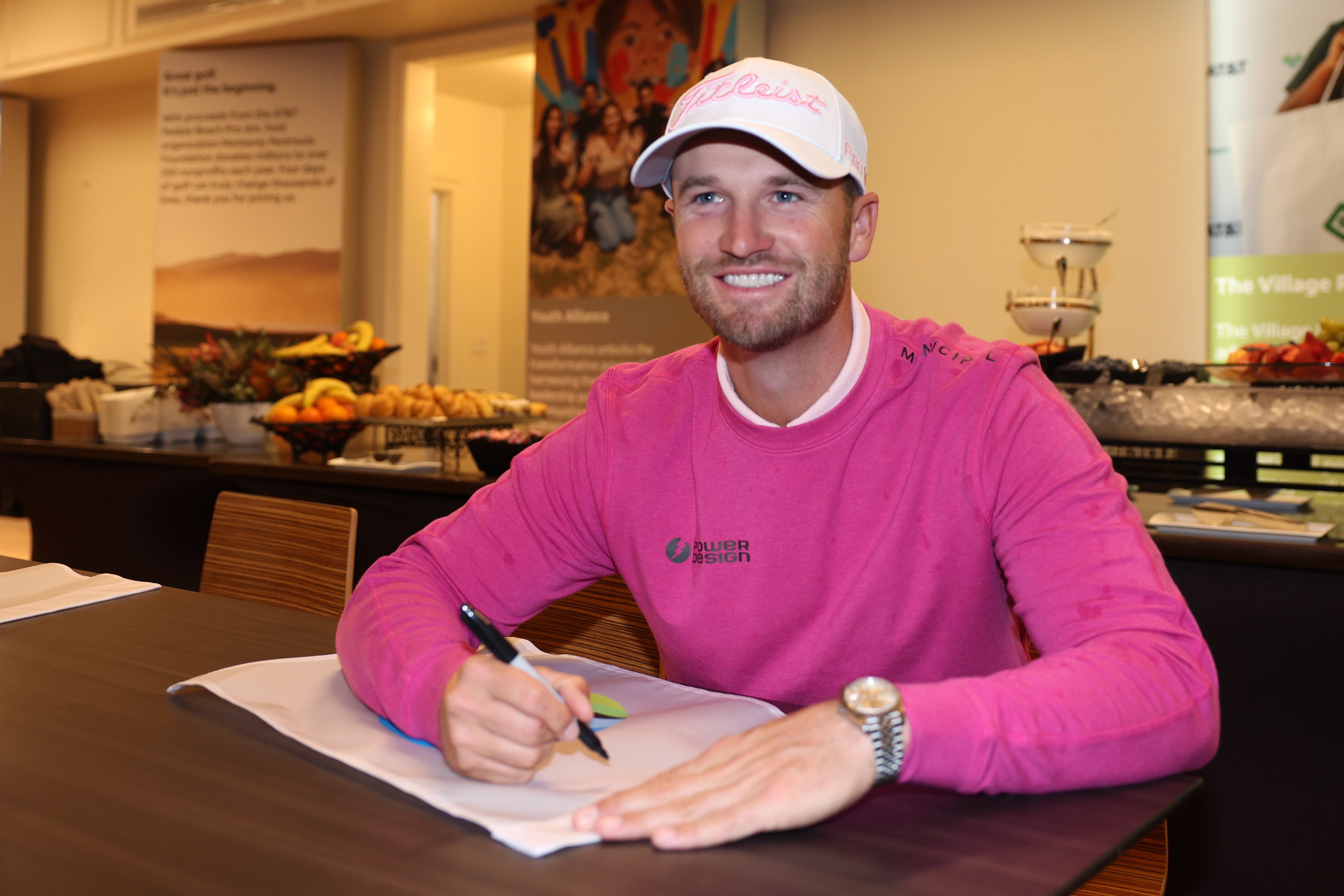 Wyndham Clark signs pin flags after winning the AT&T Pebble Beach Pro-Am last week