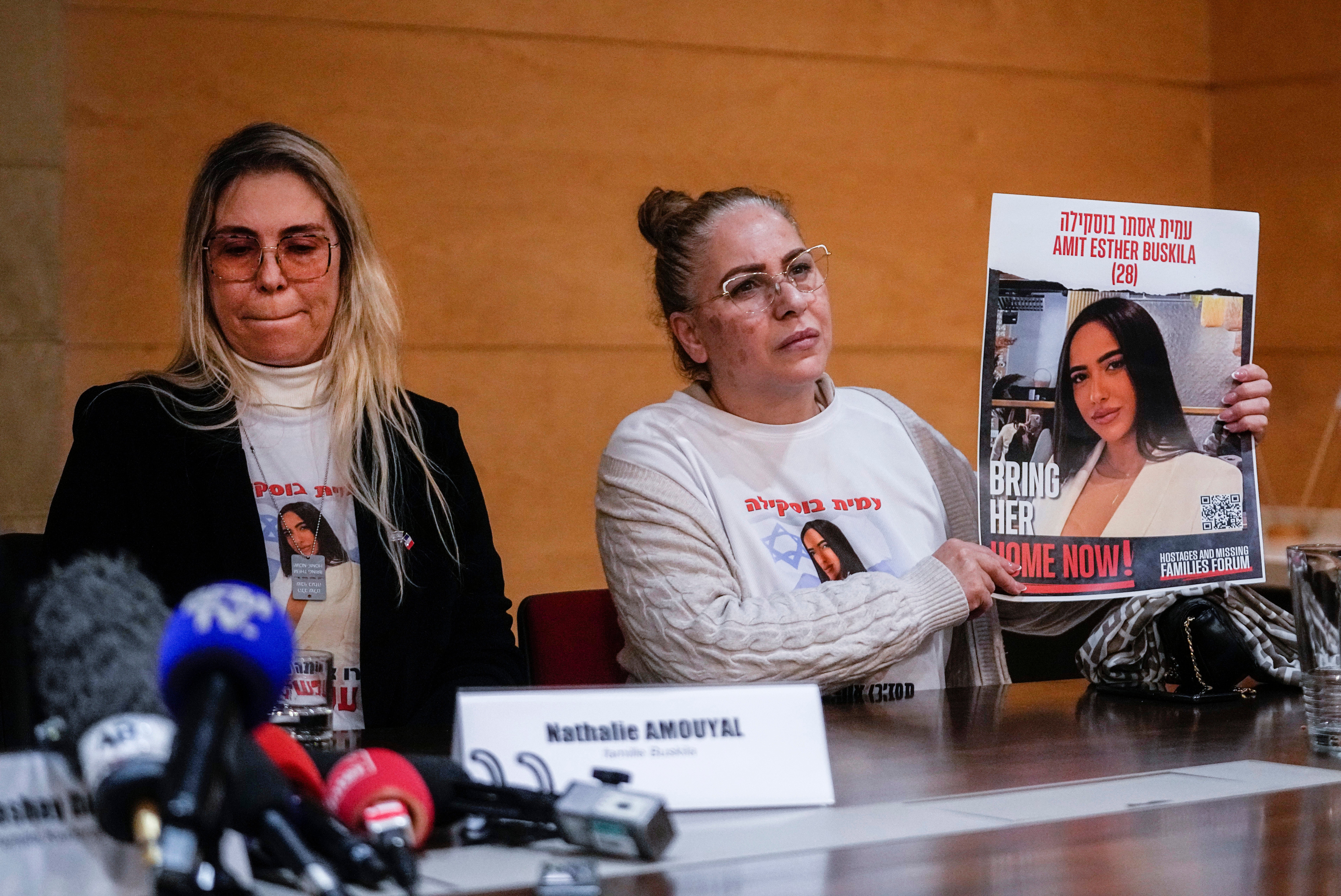 Alin Atias, right, holds a picture of her daughter Amit Buskila