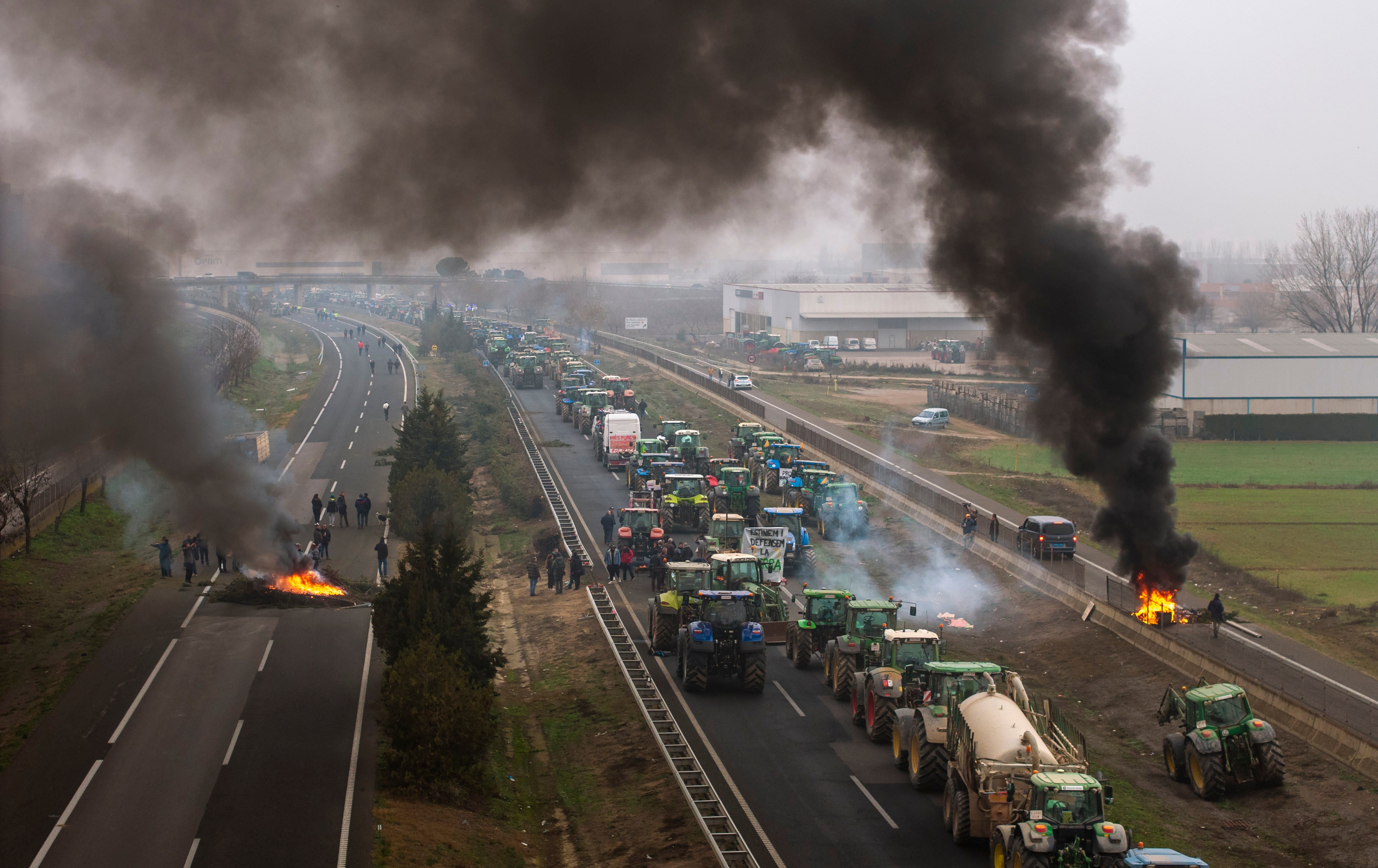 Farmers make barricades after blocking a highway during a protest near Mollerussa, northeast Spain