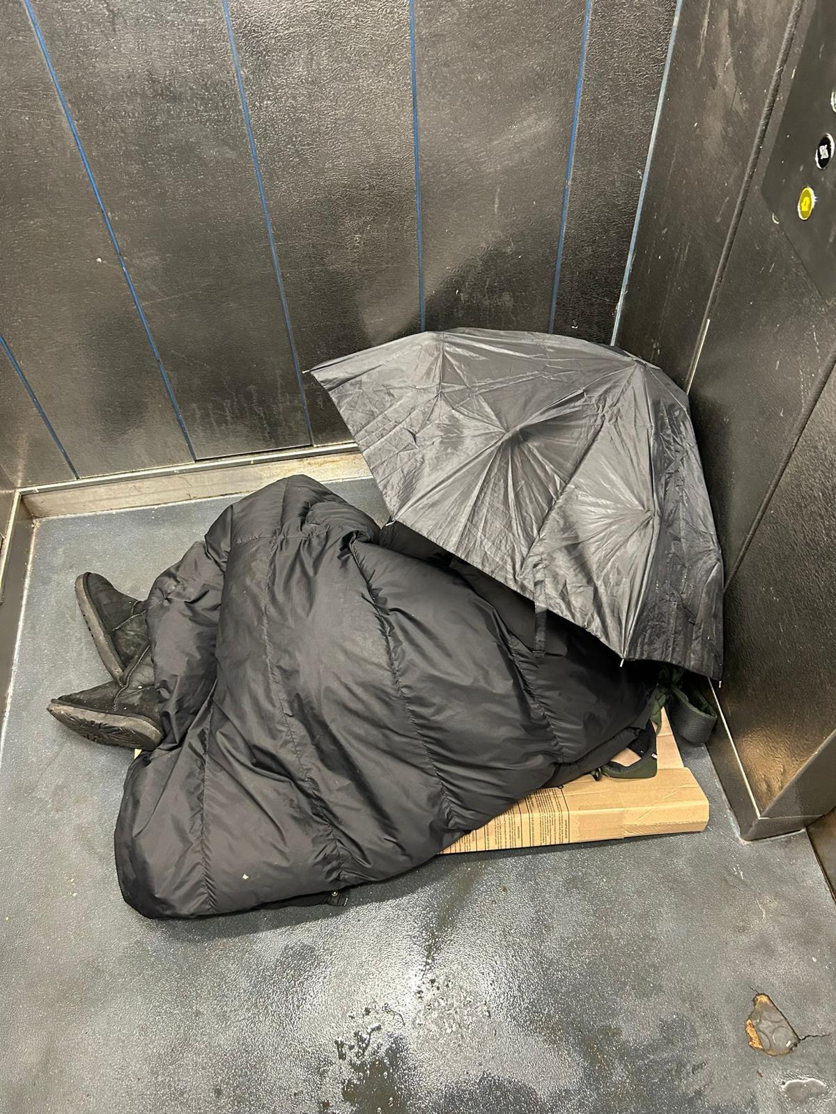 A person sleeping inside one of the lifts at the estate