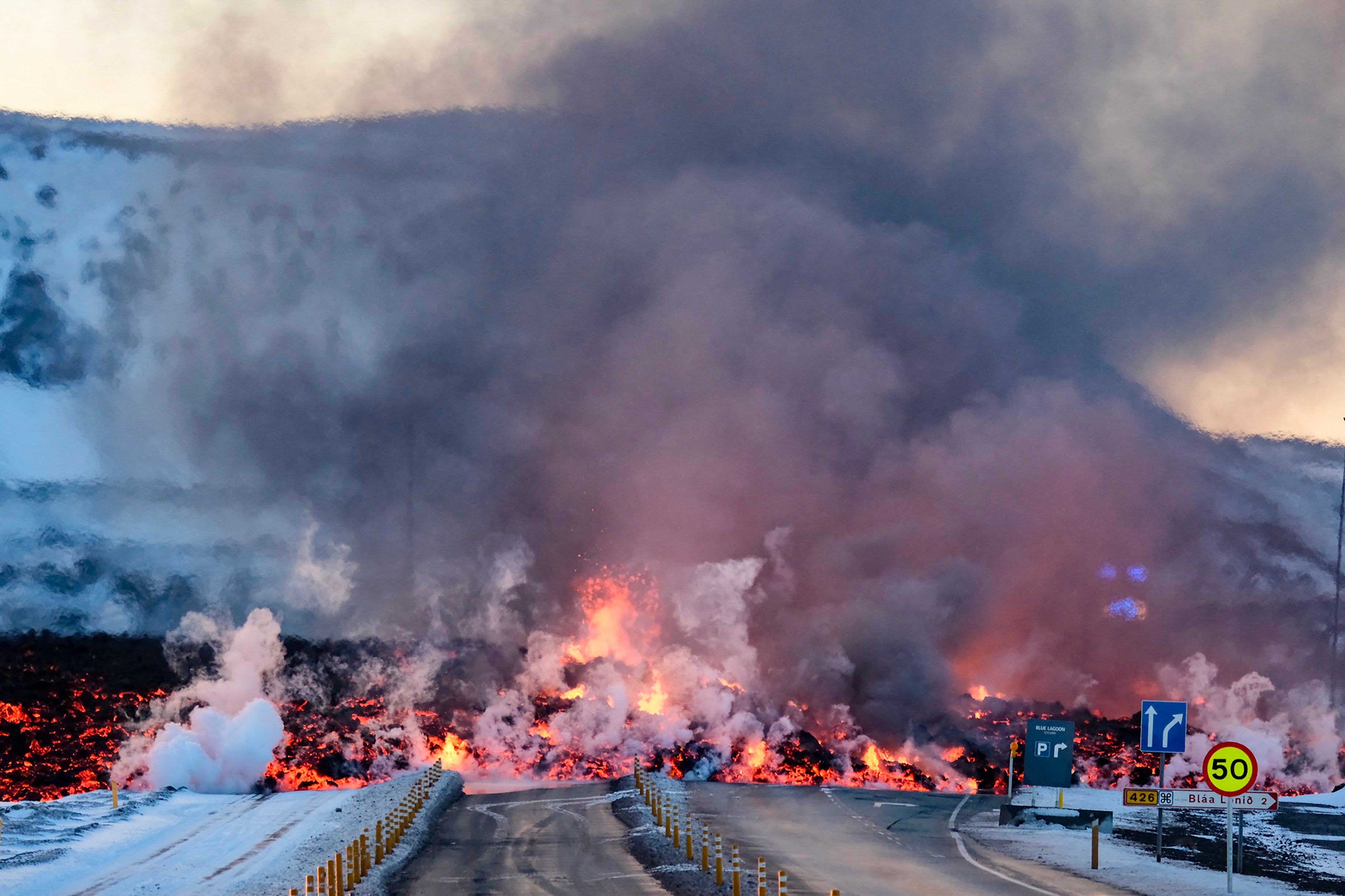 Molten lava blocking the road after another volcanic eruption