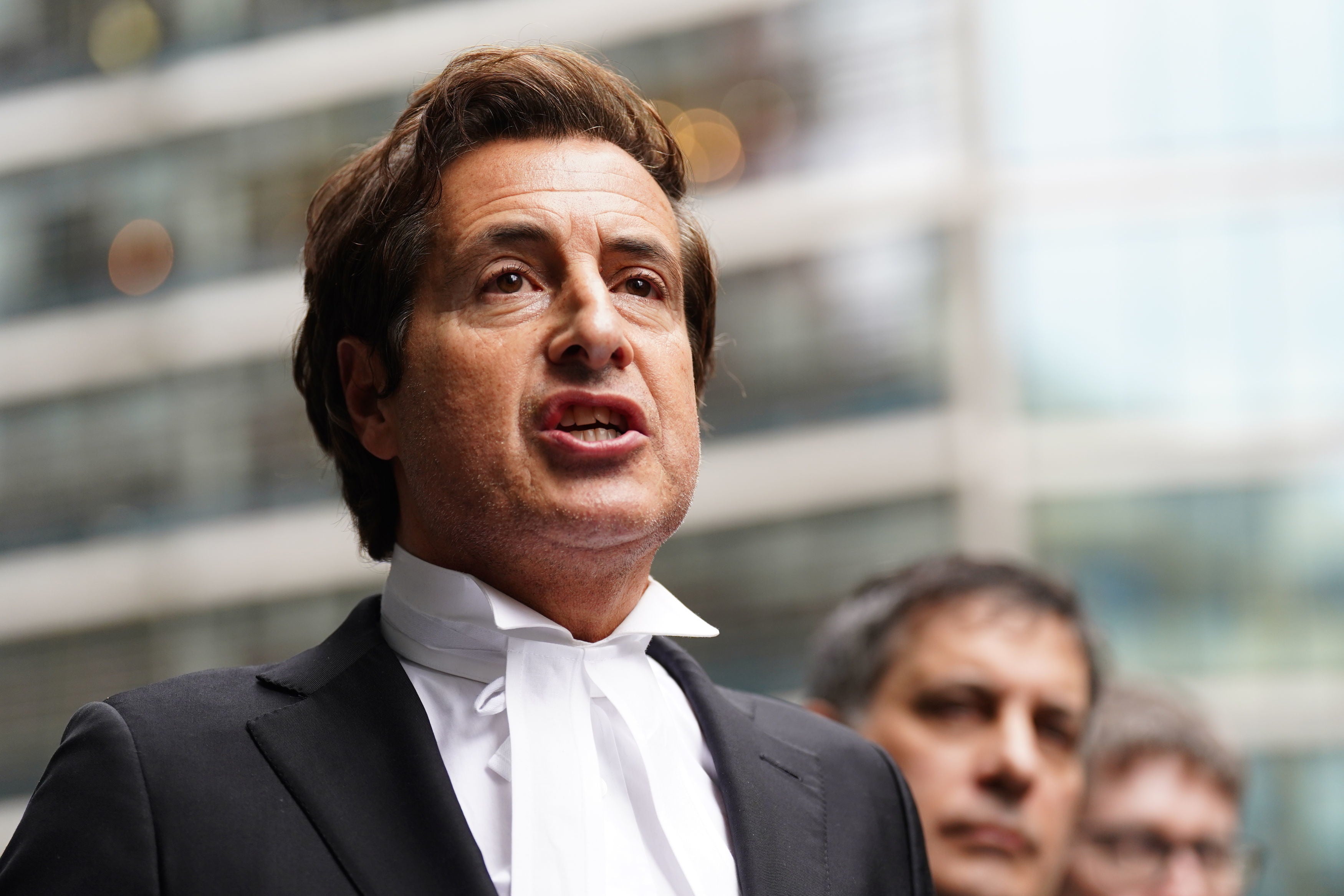 David Sherborne speaking to the media outside of the Rolls Building in central London on Friday