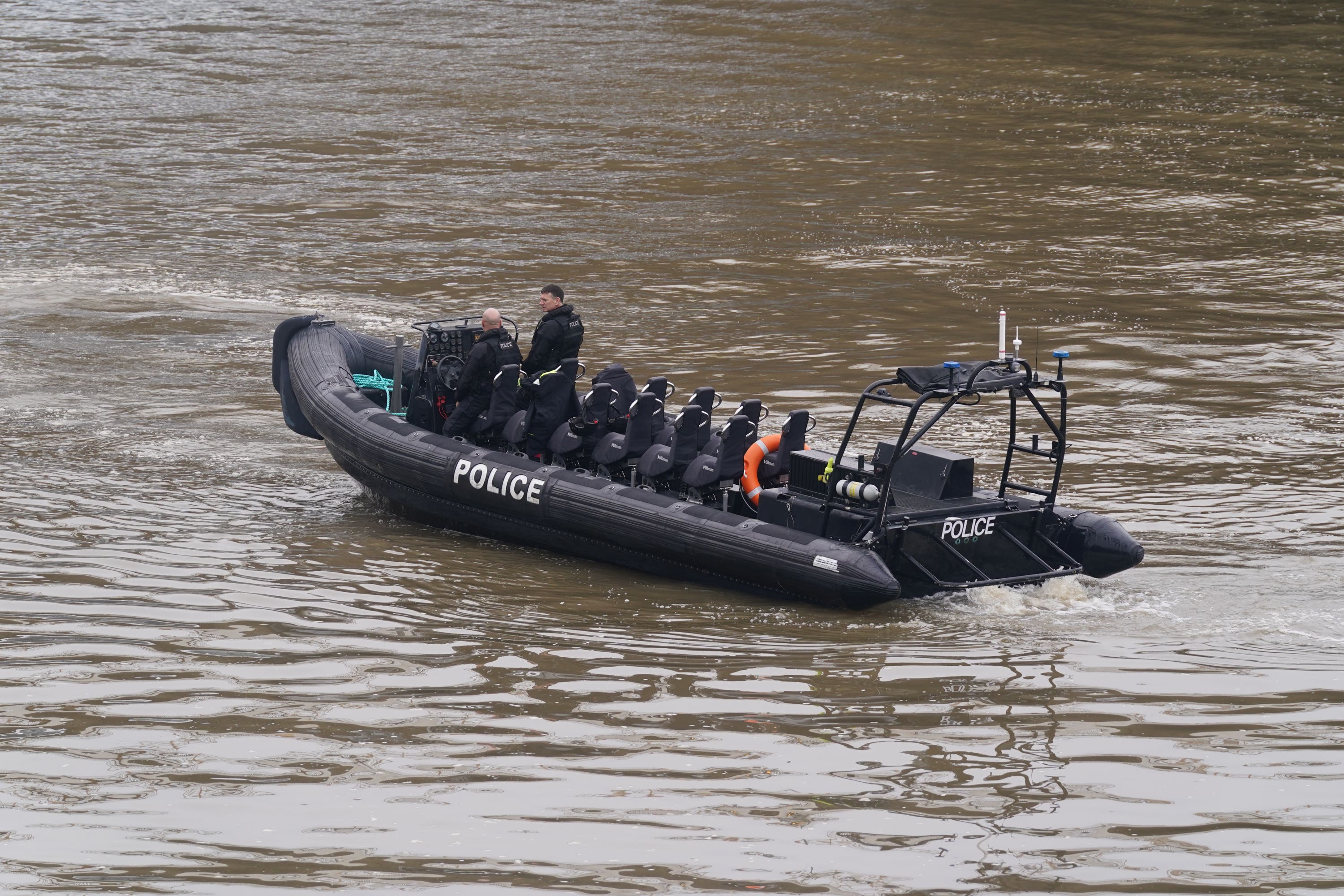 Members of the Metropolitan Police Marine Policing Unit pass near to Chelsea Bridge (Lucy North/PA)