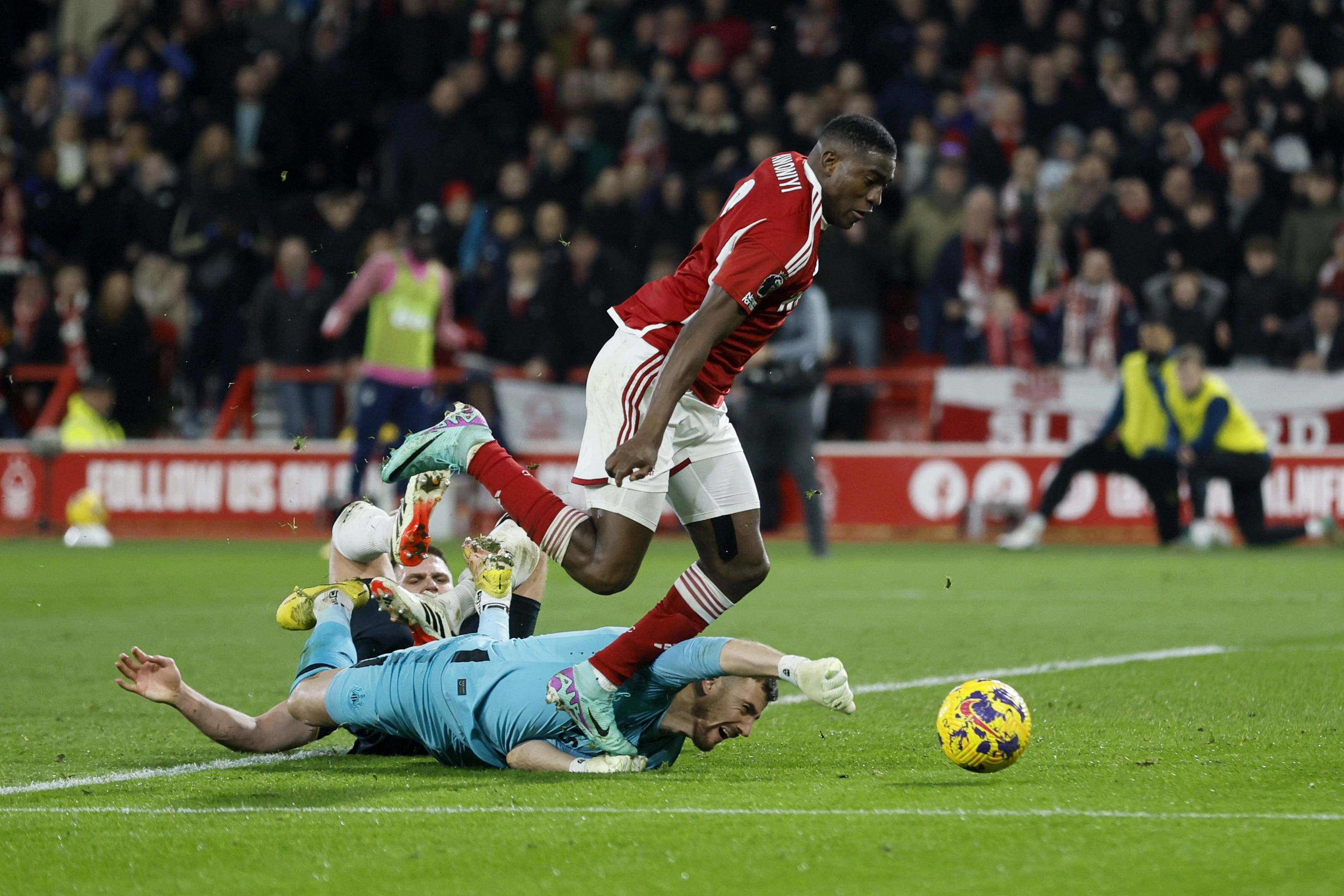 Taiwo Awoniyi tangles with diving Newcastle goalkeeper Martin Dubravka (Richard Sellers/PA)