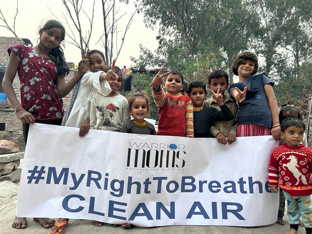 Children holding a banner of Warrior Moms in Delhi