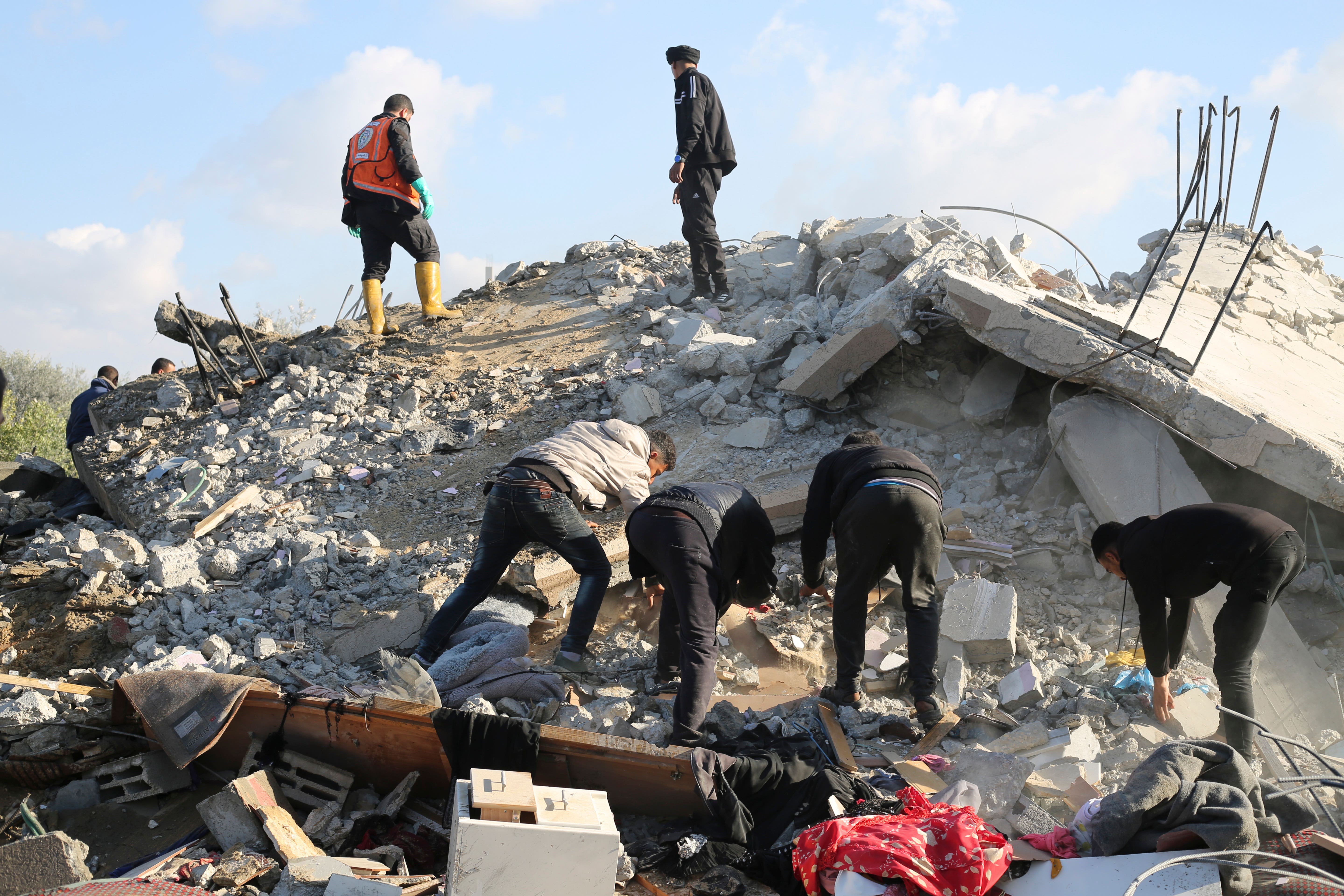 Palestinians search for survivors after an Israeli air strike on a residential building In Rafah (AP Photo/Hatem Ali)