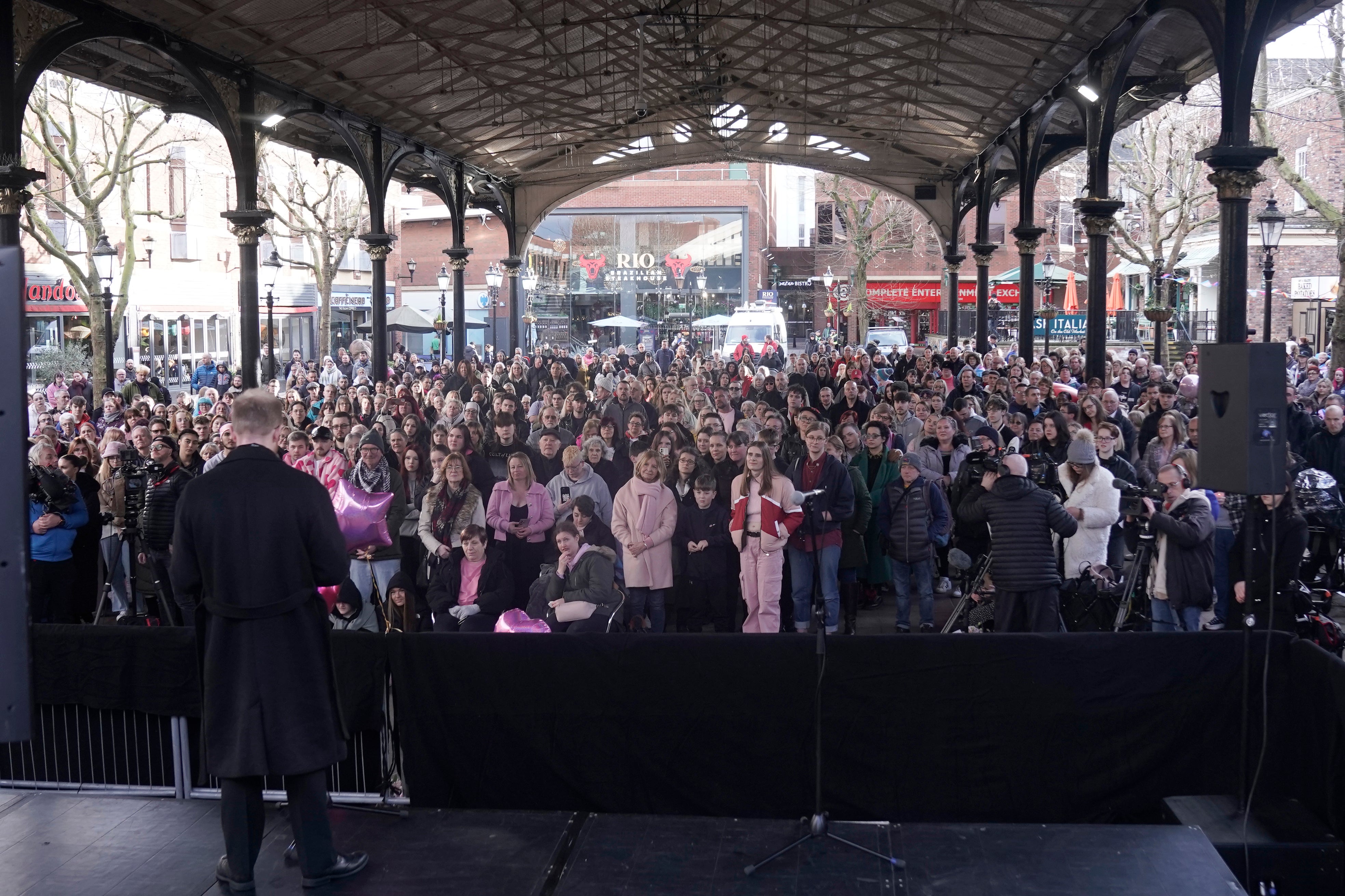 People, many wearing pink, attending a vigil in Golden Square, Warrington, to mark the first anniversary of the murder