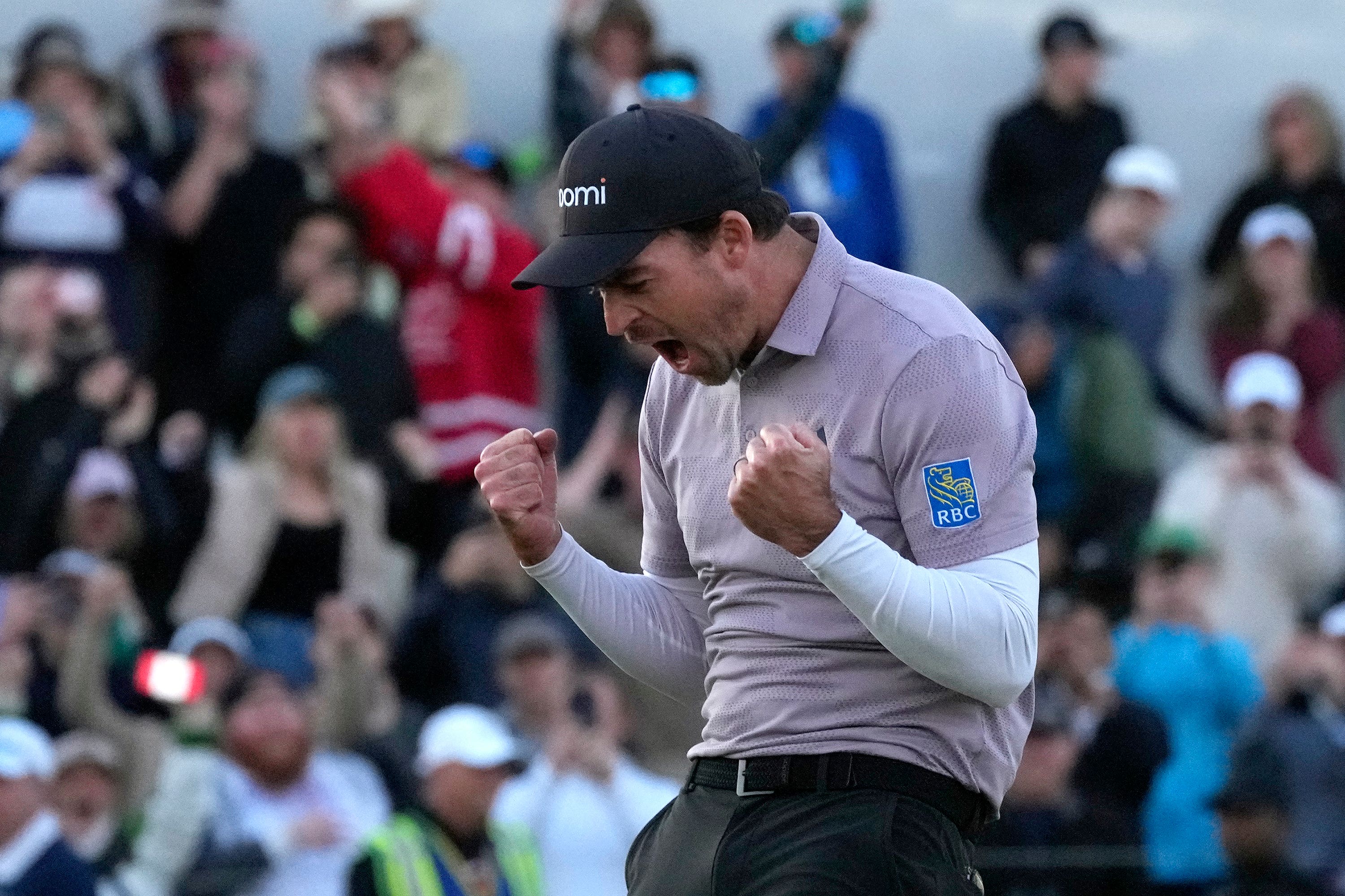 Nick Taylor, of Canada, celebrates his win over Charley Hoffman on the 18th green on the second playoff hole of the Phoenix Open (Ross D Franklin/AP)