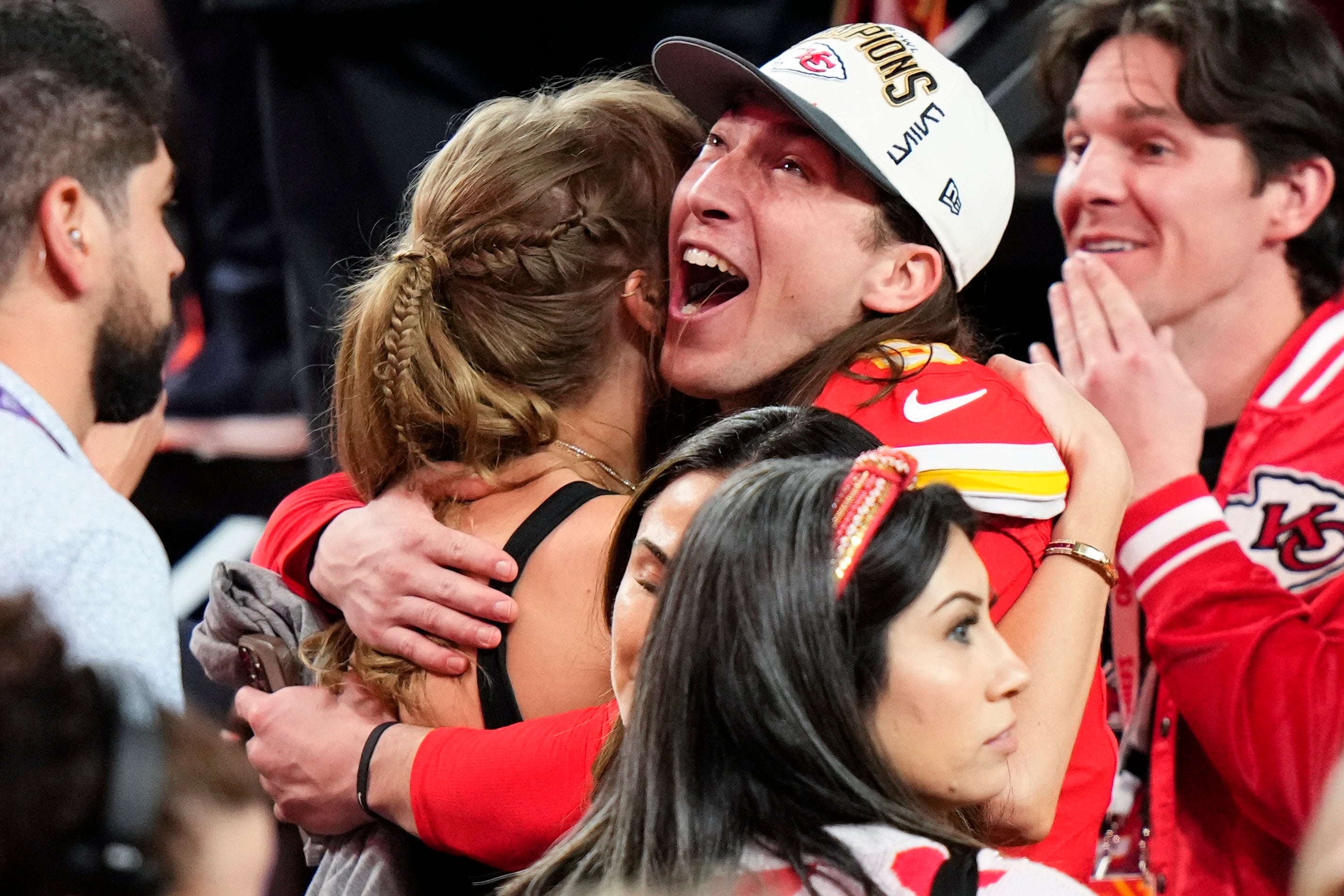 Kansas City Chiefs kicker Harrison Butker embarces Taylor Swift after Super Bowl 58