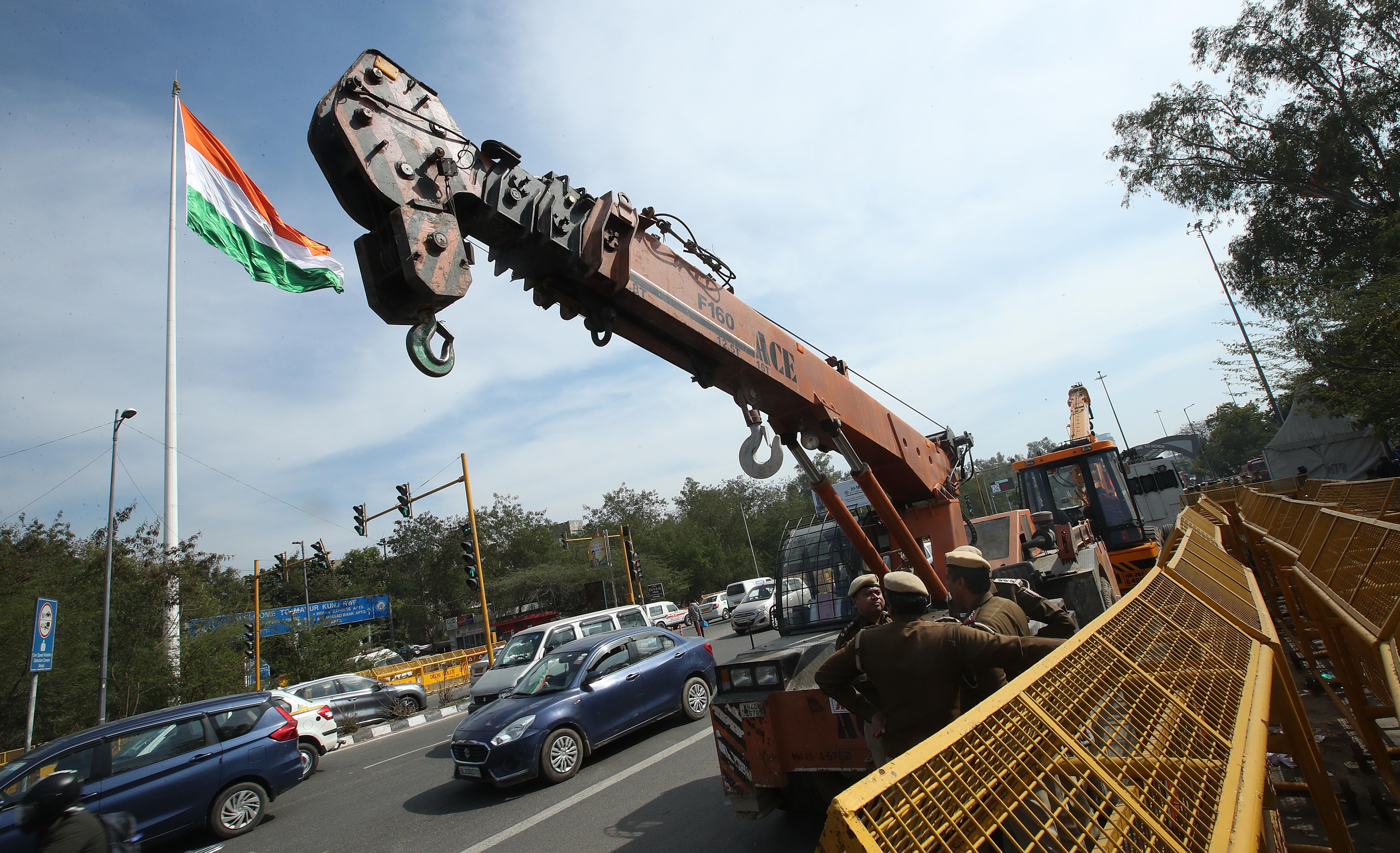 Indian soldiers stand near cranes to deal with the farmers’ tractors near the Delhi Noida Border, New Delhi, India, 08 February 2024