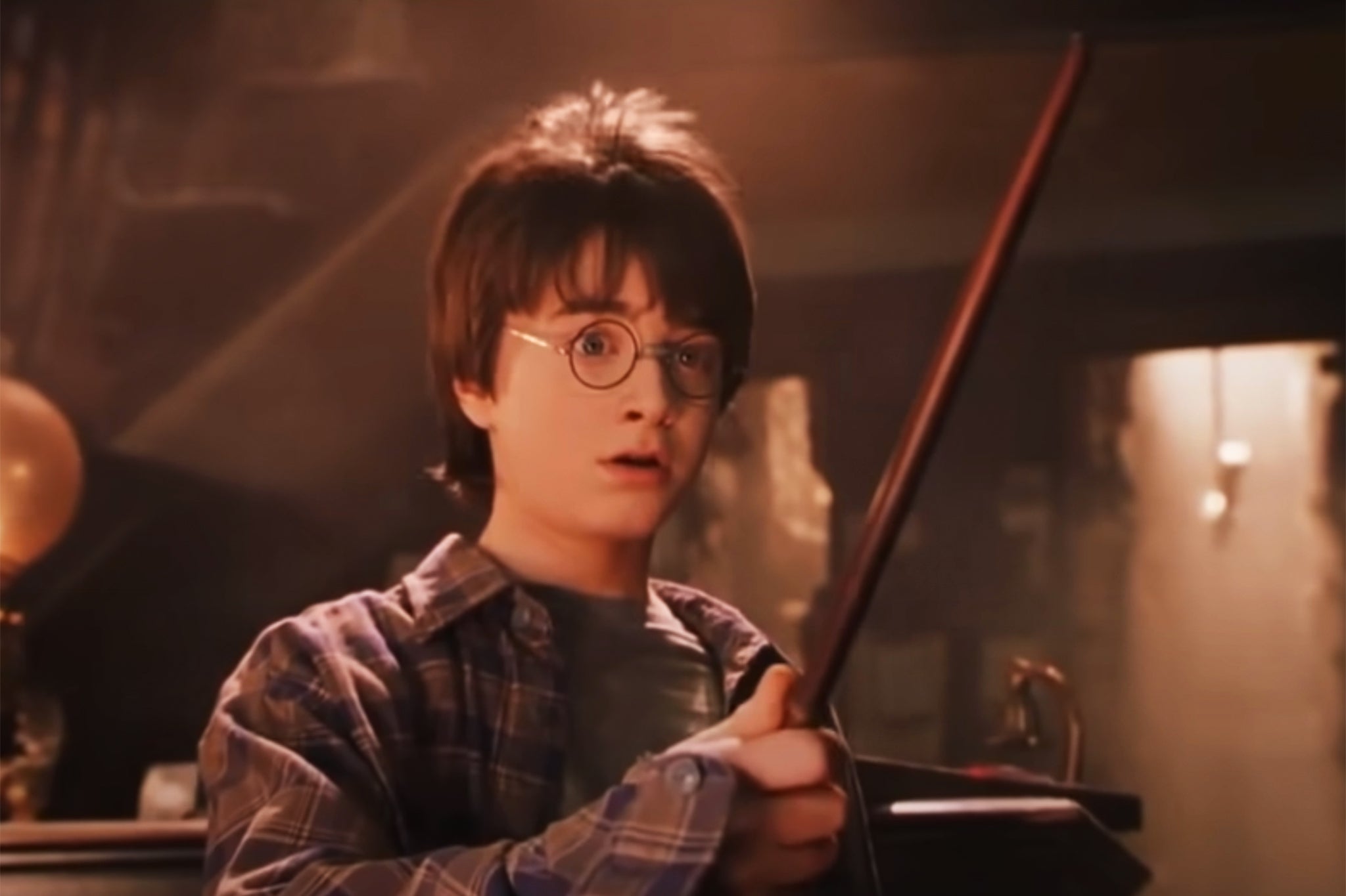 Daniel Radcliffe as Harry Potter with wand in hand