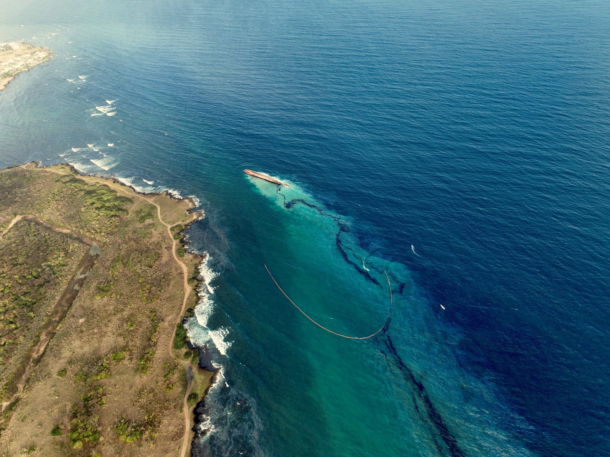 An oil spill in Tobago Island, Trinidad and Tobago, leaves black residue on beach