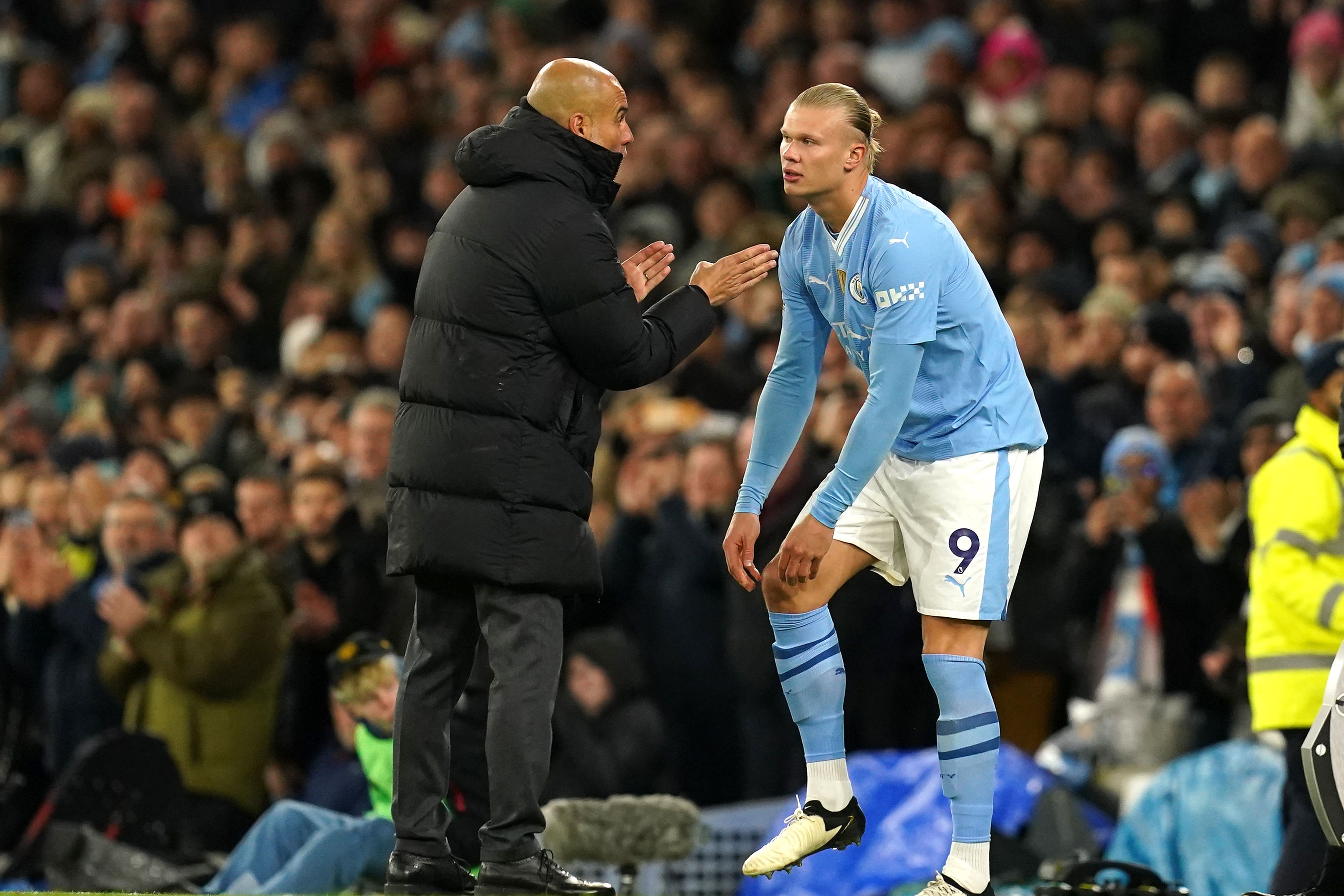 Manchester City manager Pep Guardiola speaks with Erling Haaland (Martin Rickett/PA)