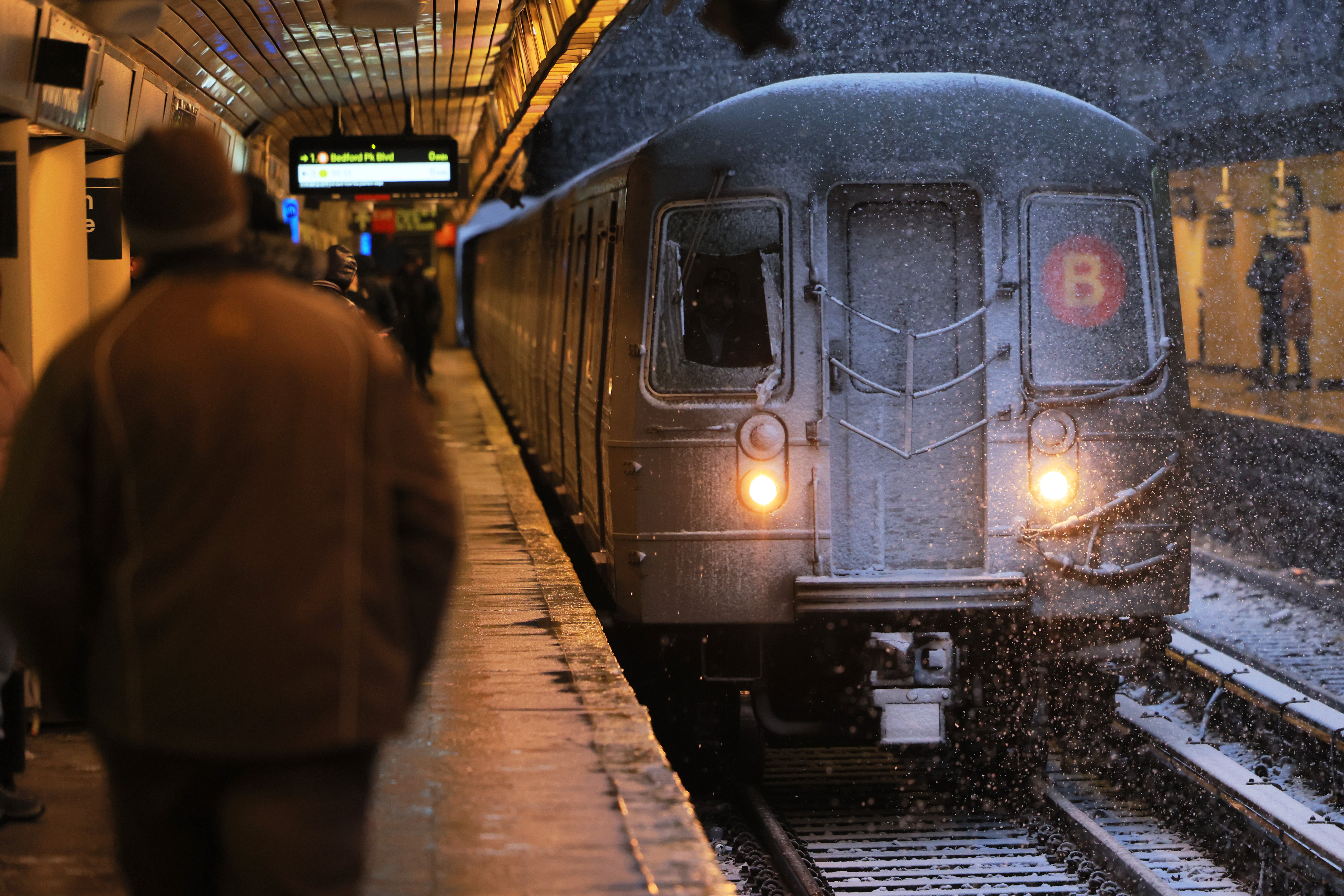 A man has been charged with attempted murder after he allegedly pushed his girlfriend onto the tracks of a Manhattan subway