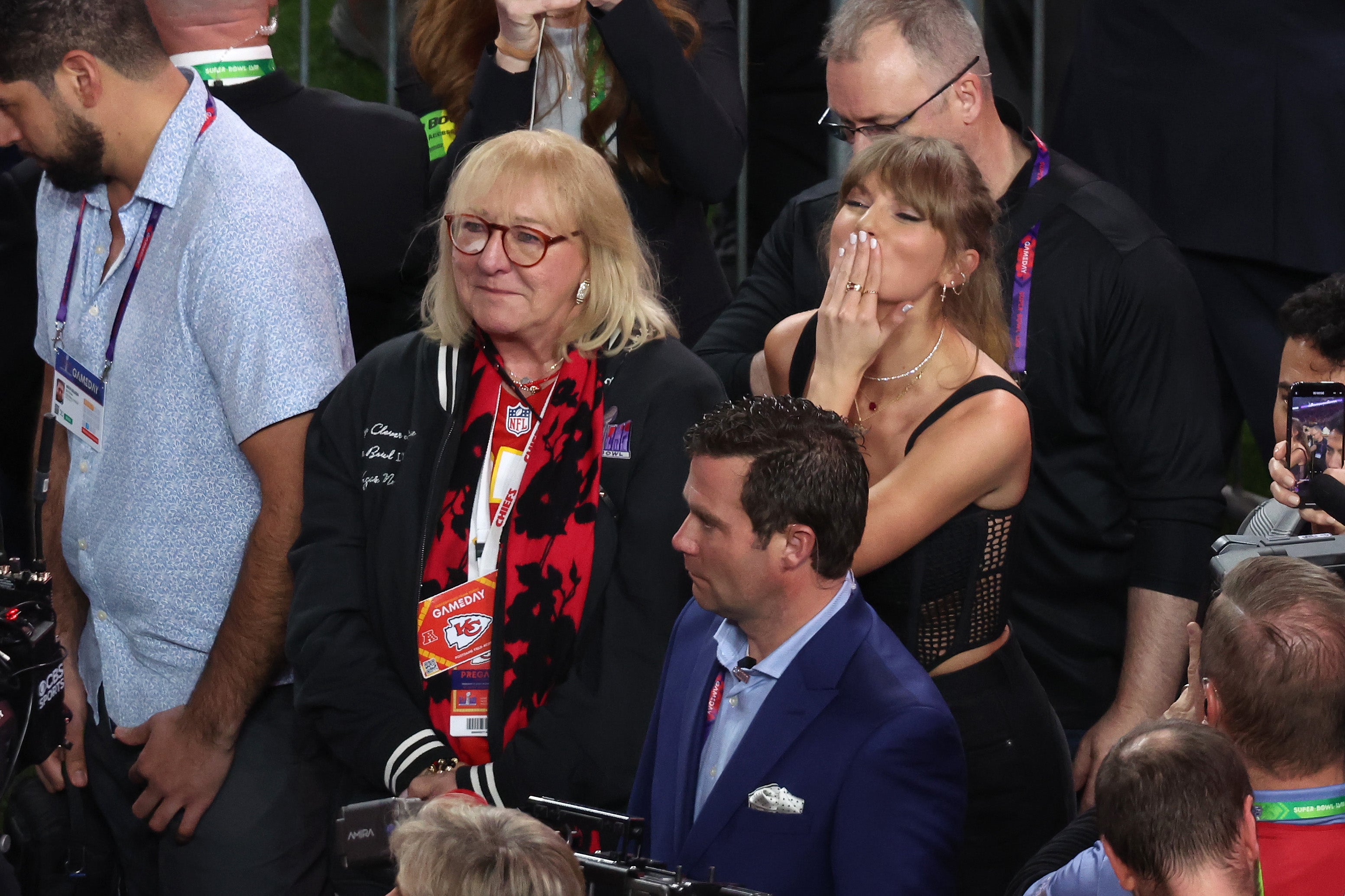 Taylor Swift blows a kiss on the field at Allegiant Stadium during Super Bowl LVIII