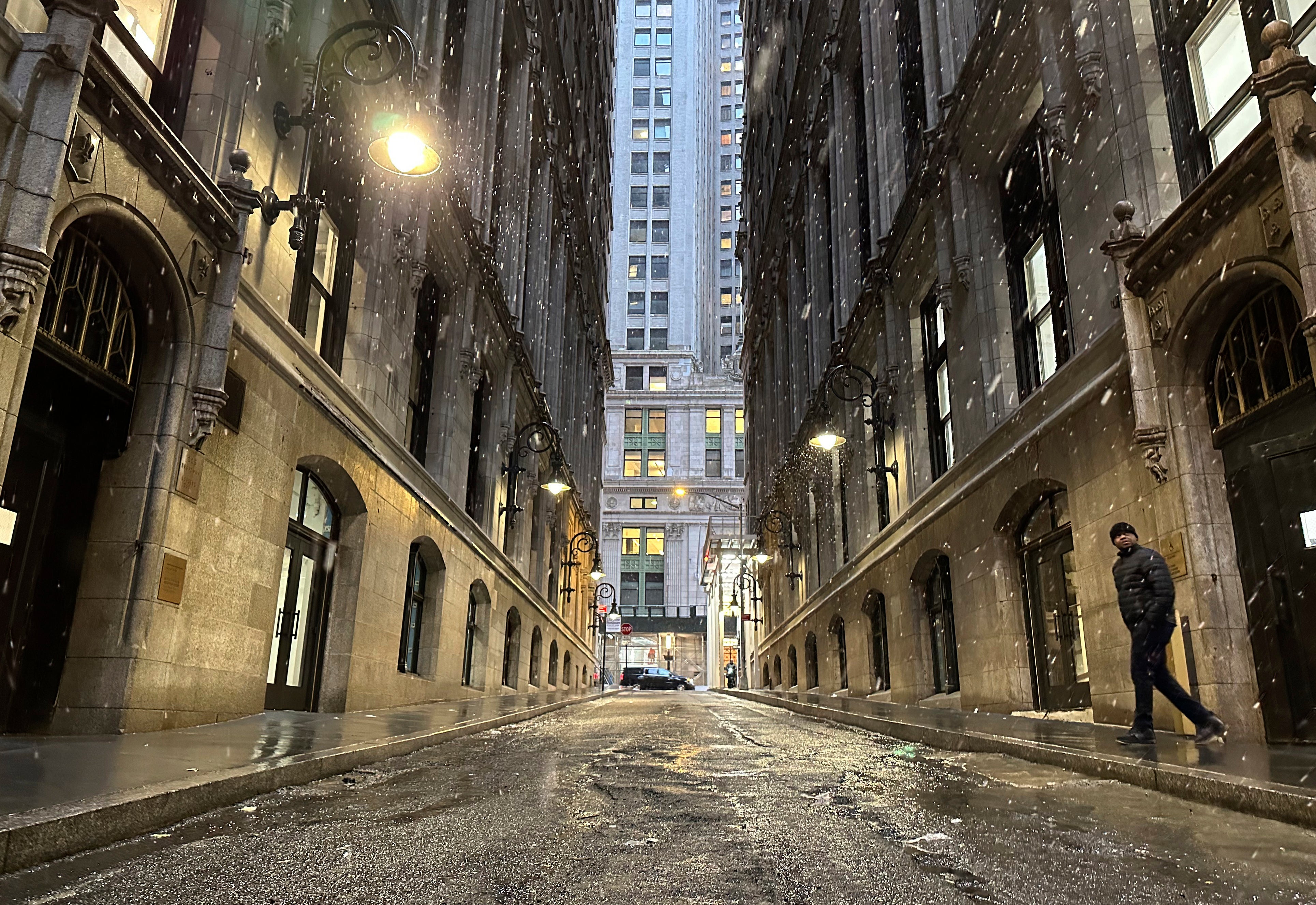 A man steps out on Thames Street in lower Manhattan