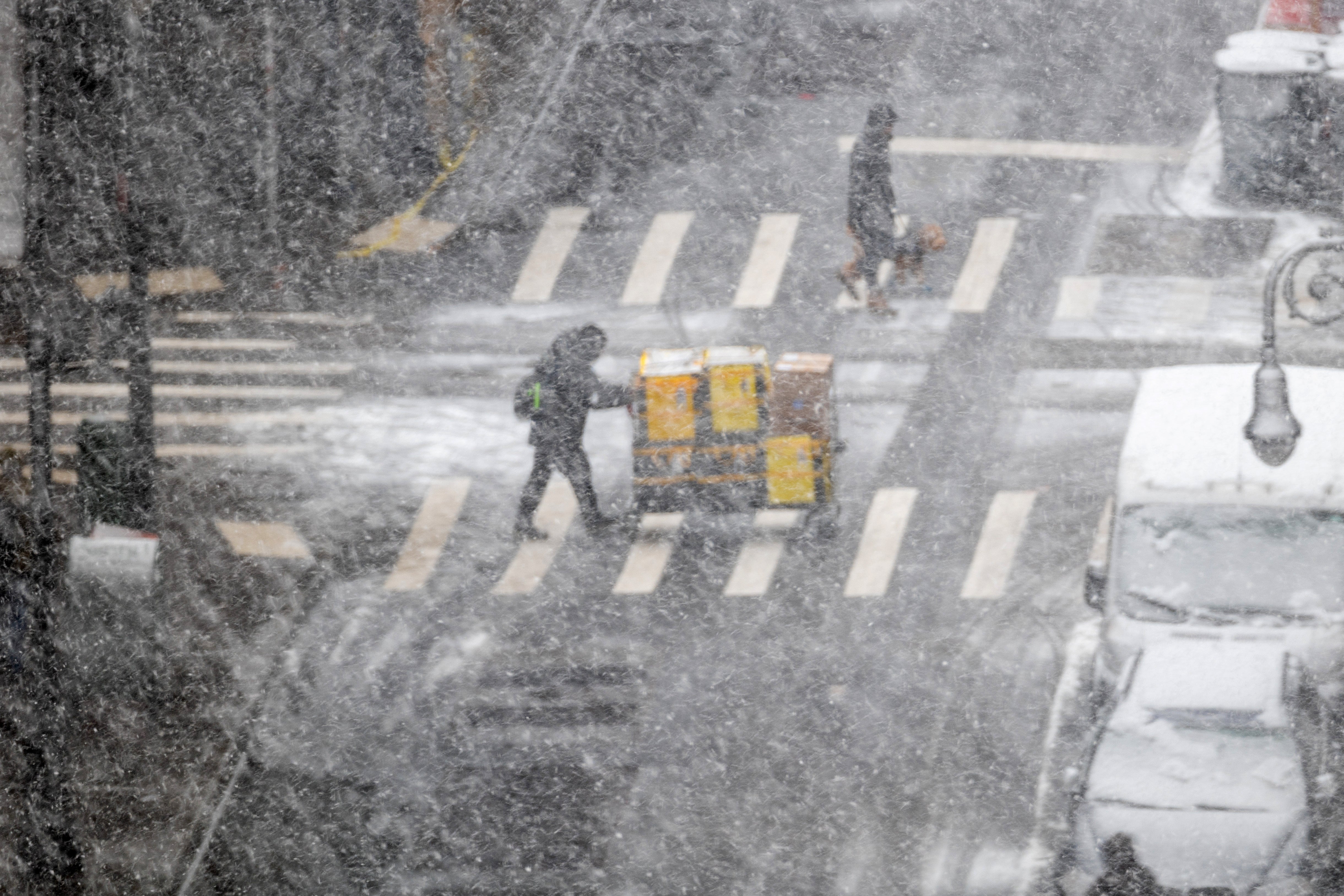 People walk through the blowing snow in Manhattan