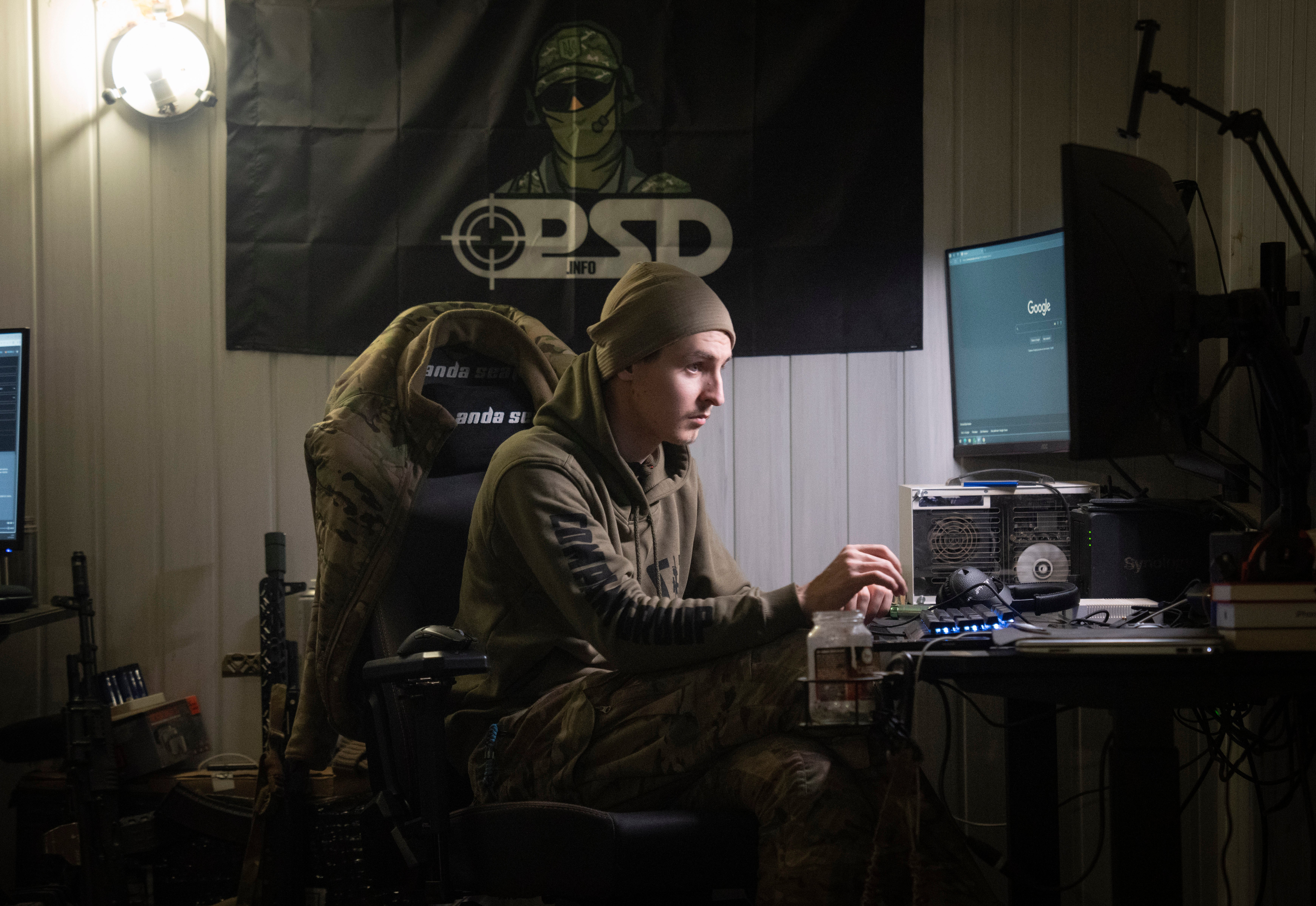 A Ukrainian officer Maksym listens to Russian chatter in a shelter near Bakhmut, Donetsk region, Ukraine