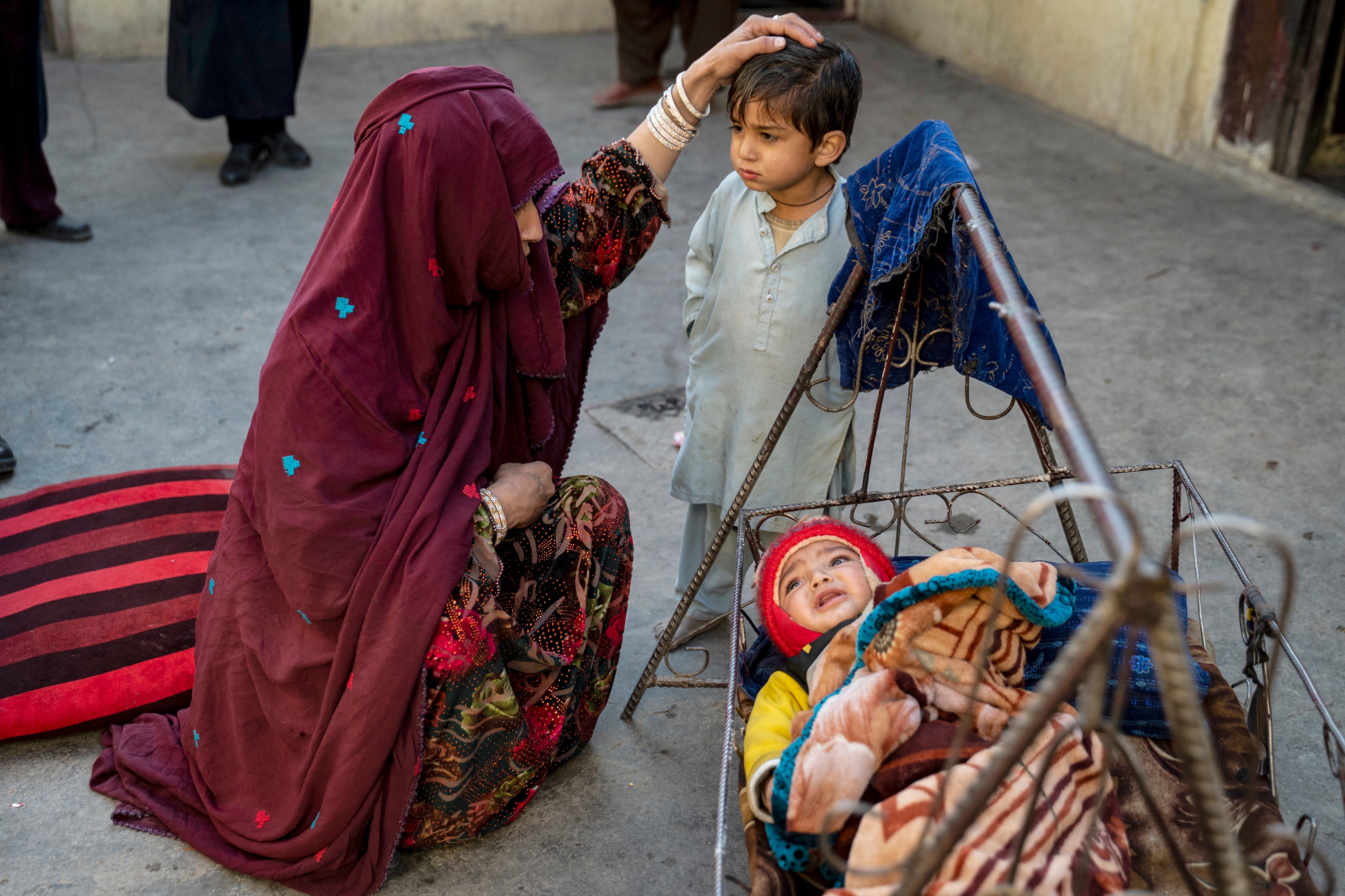 An Afghan woman refugee Najiba 25 (L) deported from Pakistan, with her son Hasibullah 5 (C) and daughter Nazia at a house in Bagrami district on the outskirts of Kabul