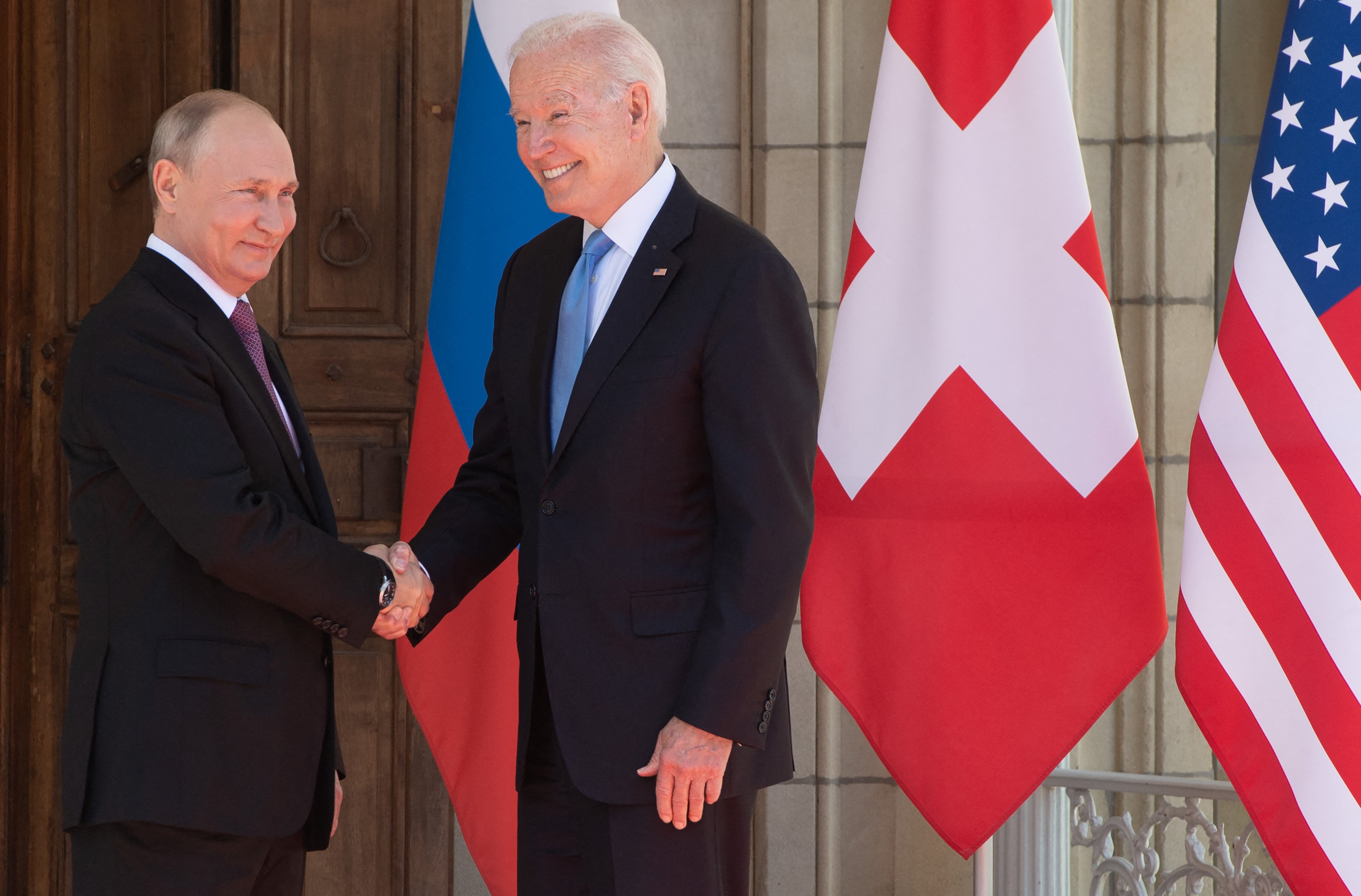 Joe Biden and Putin shake hands as they arrive for a US-Russia summit at Villa La Grange in Geneva in 2021