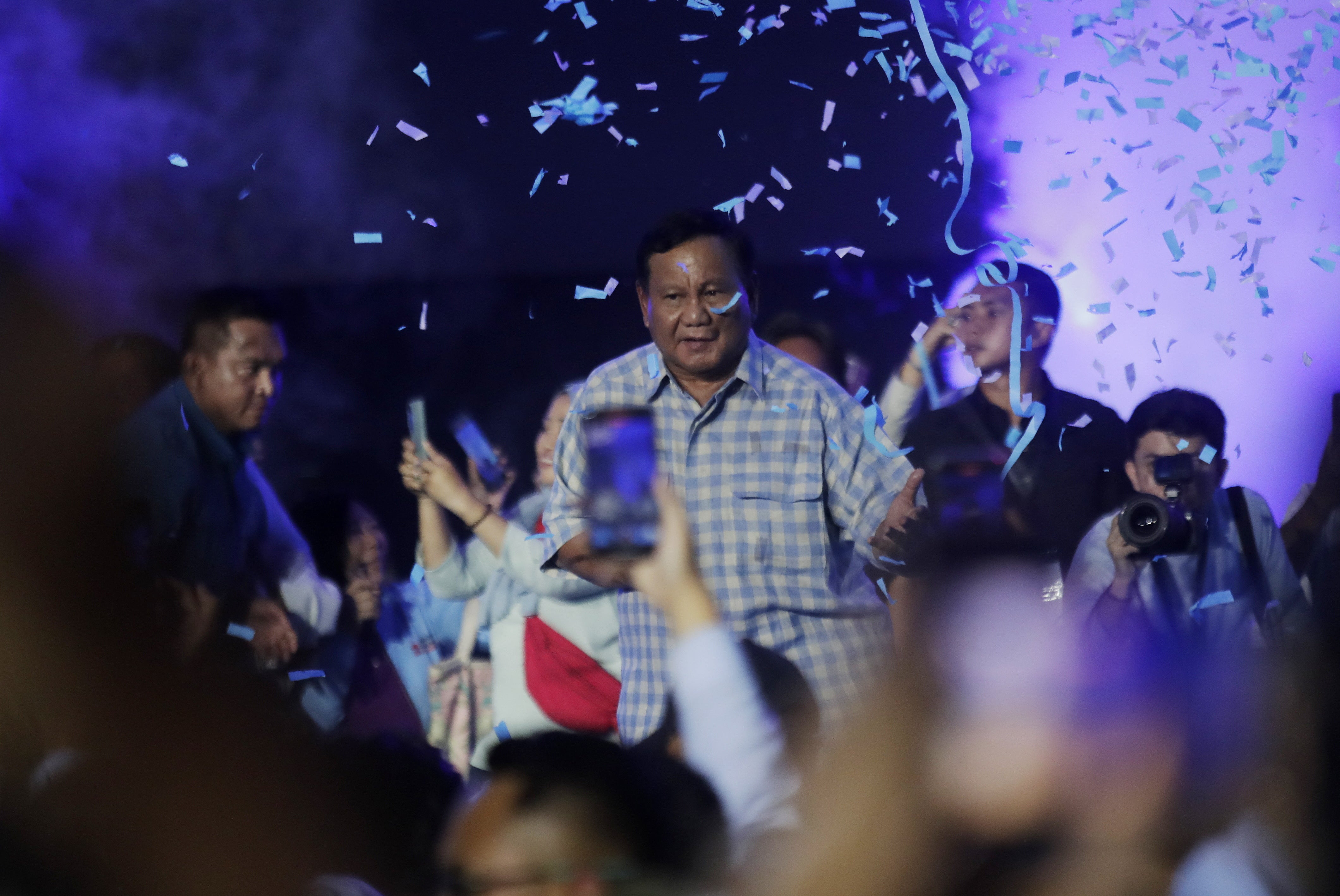 Indonesian Defence Minister and presidential candidate Prabowo Subianto (C) celebrates after claiming victory in the Presidential elections at Istora Stadium