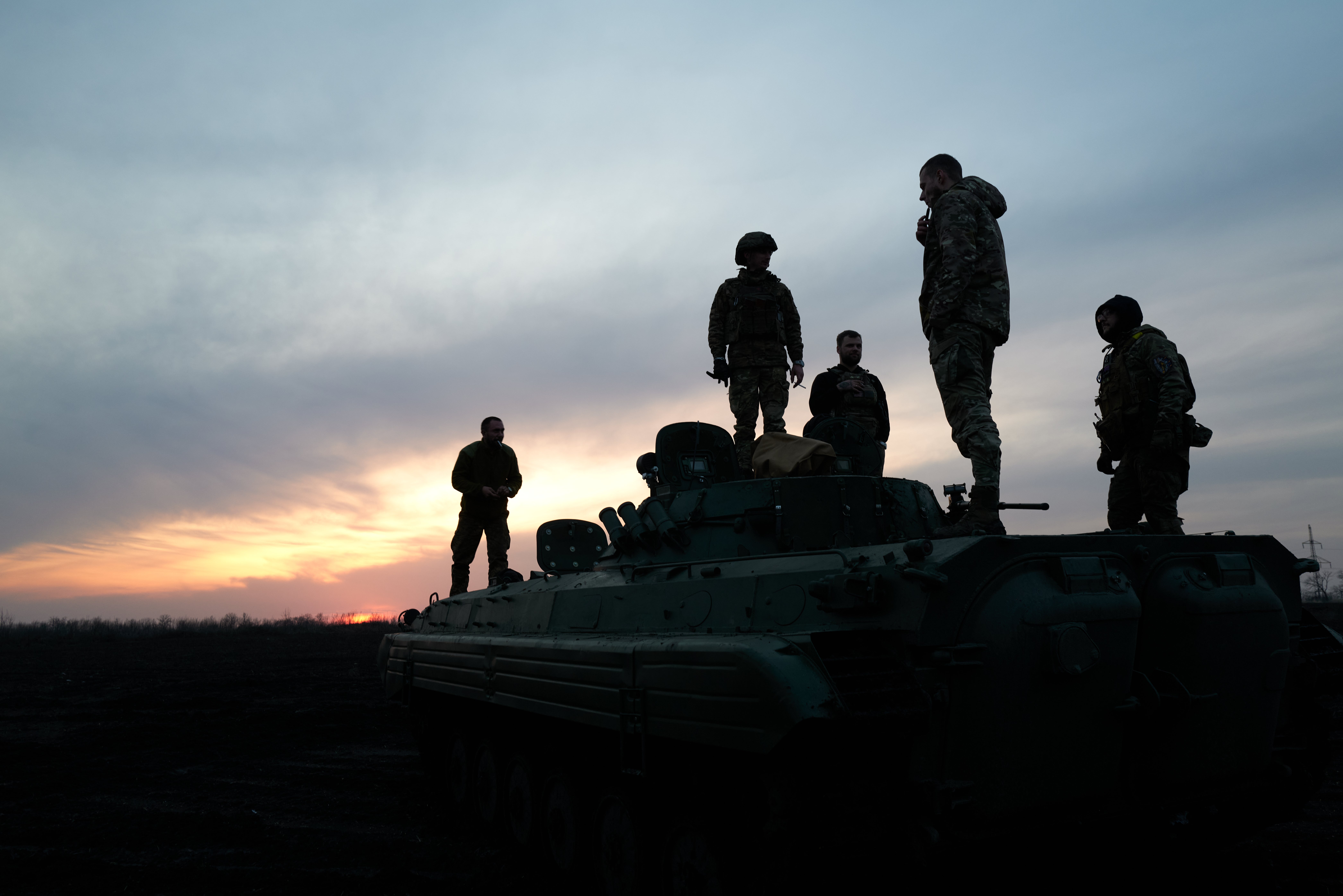 Soldiers stand on the Armoured Infantry Vehicle 2 (BMP-2) on the road to the city, on the outskirts of Avdiivka