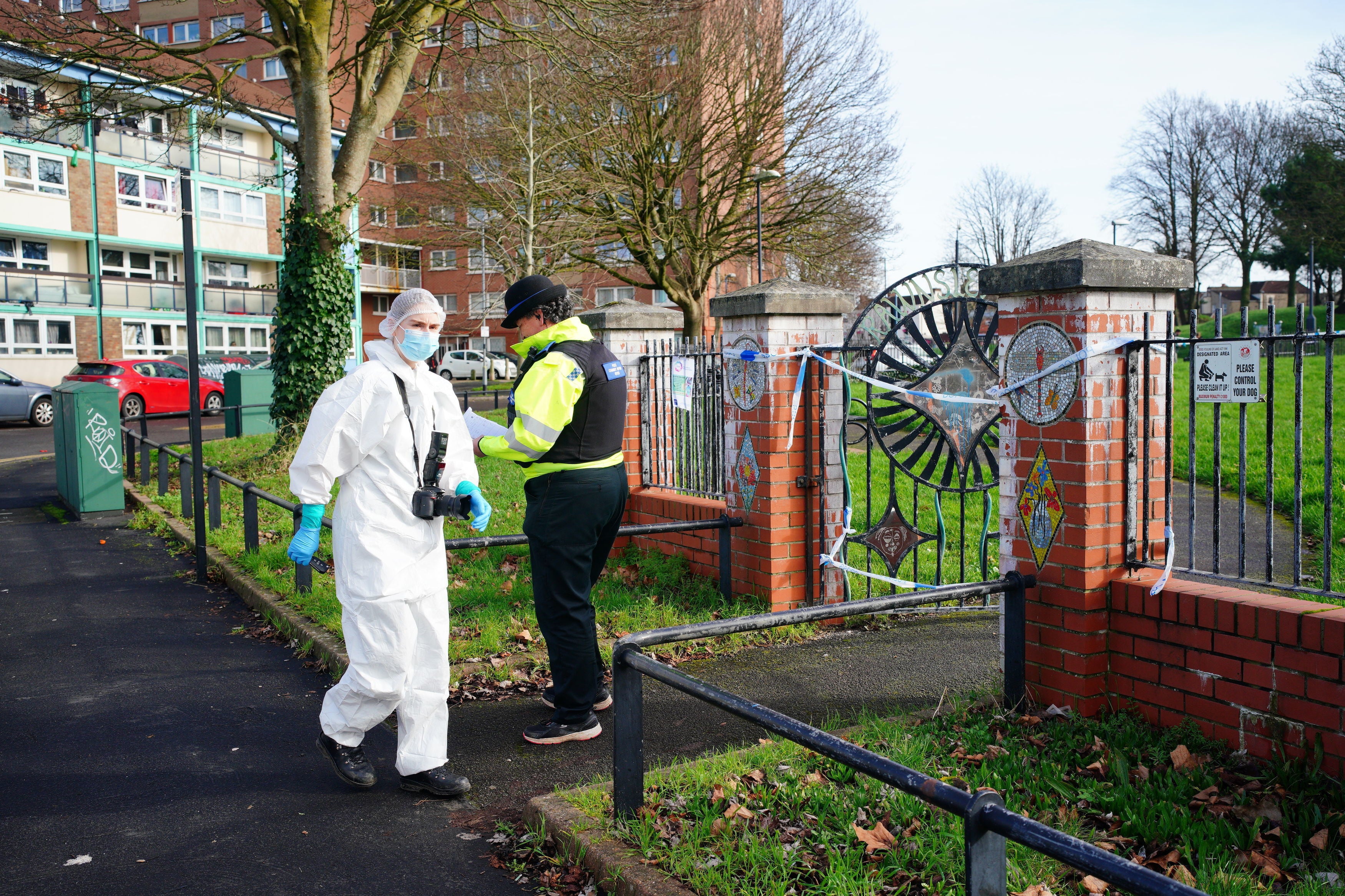 Investigators wearing white forensic suits were seen examining the scene and taking photographs on Thursday