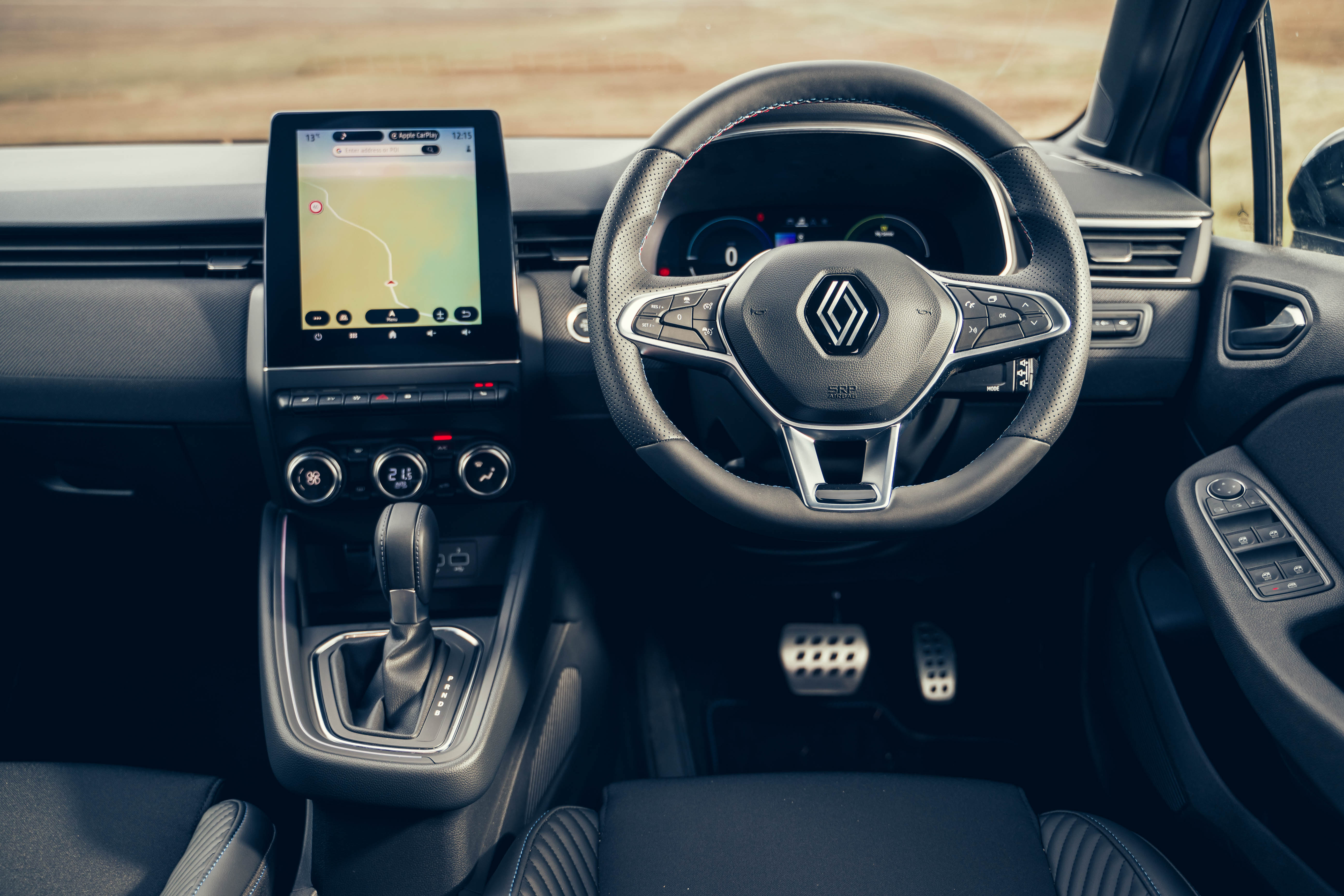 The steering wheel has the tricolour red, white and blue stitching