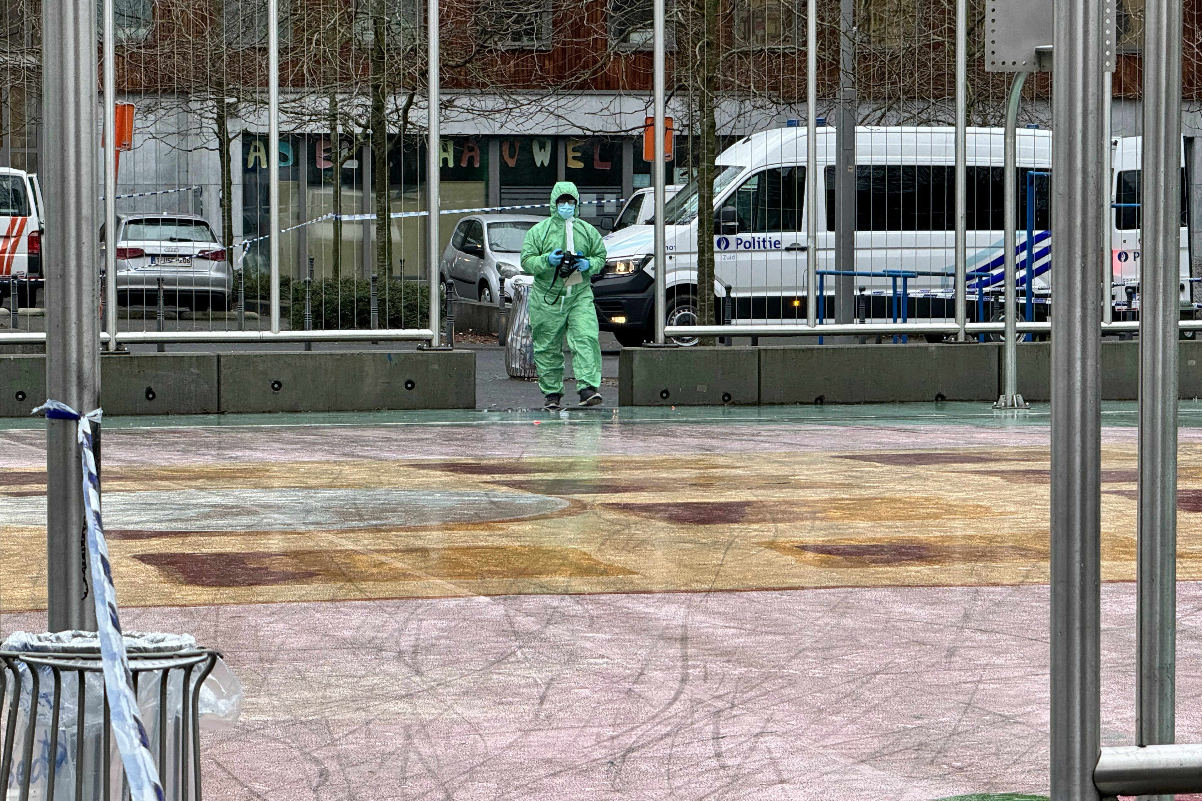 A forensic team takes photos at the scene of a shooting in Brussels, Wednesday