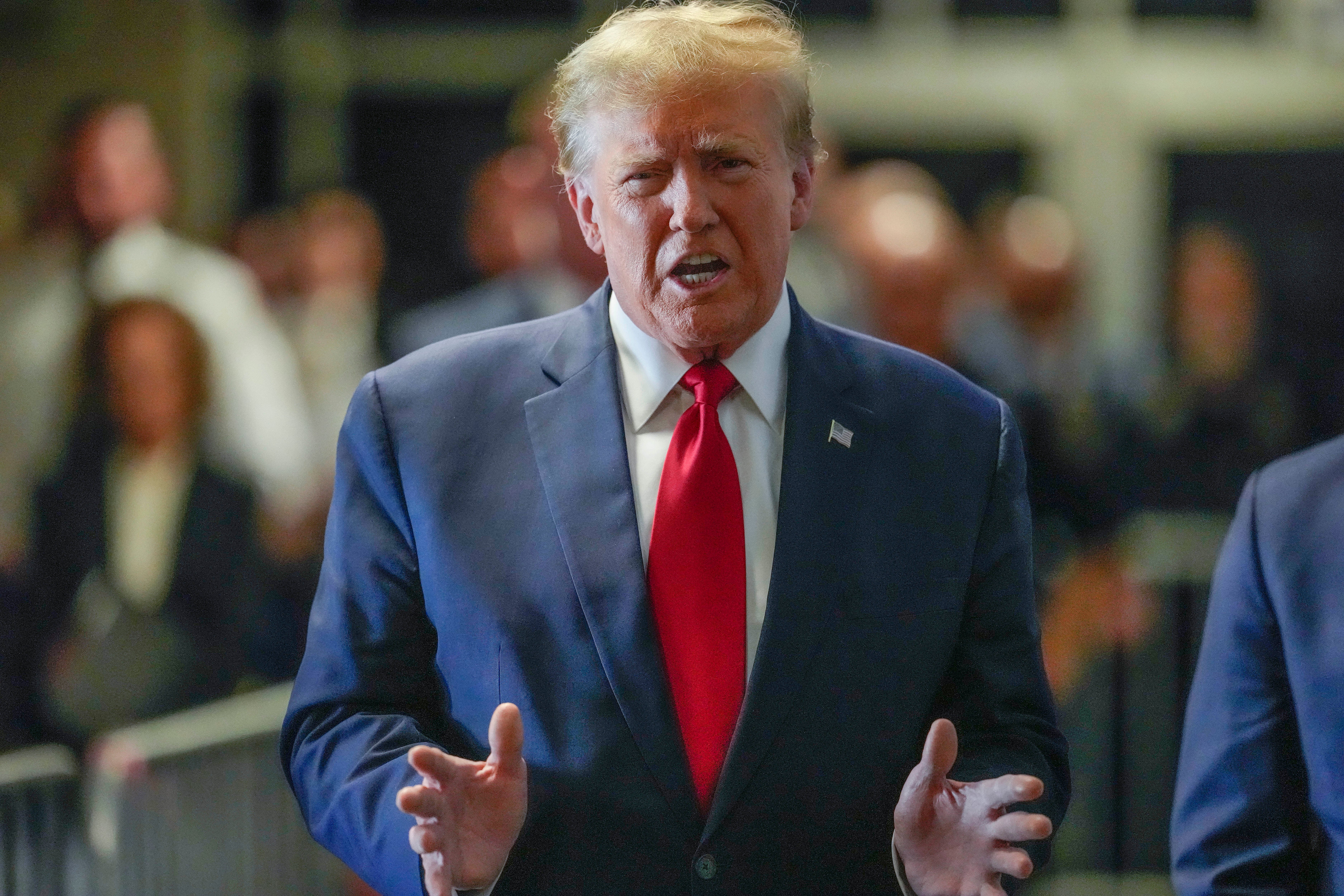 Donald Trump speaks to reporters as he arrives at Manhattan criminal court on 15 February.