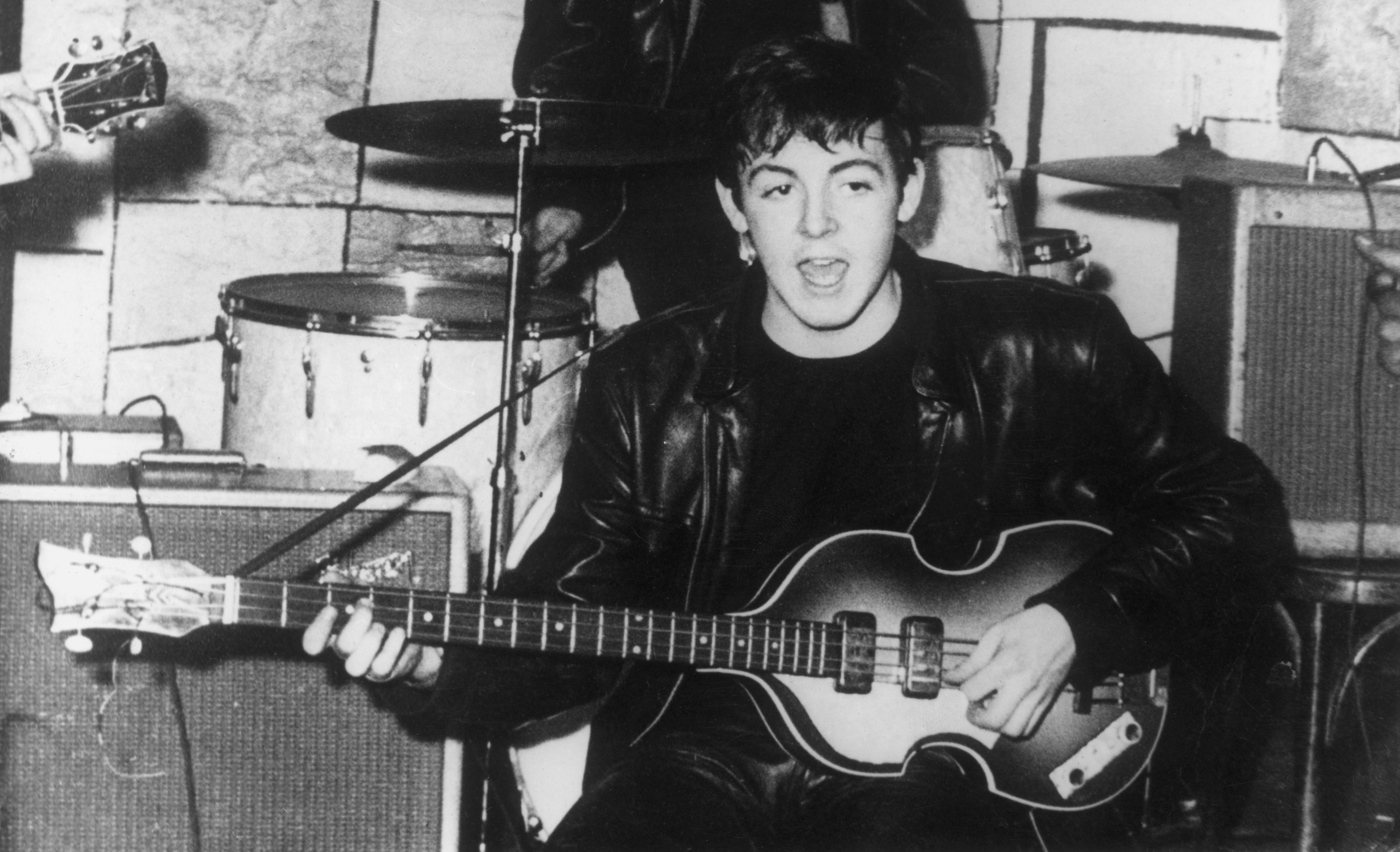 Paul McCartney onstage with his Höfner bass at the Cavern Club in Liverpool, circa 1961