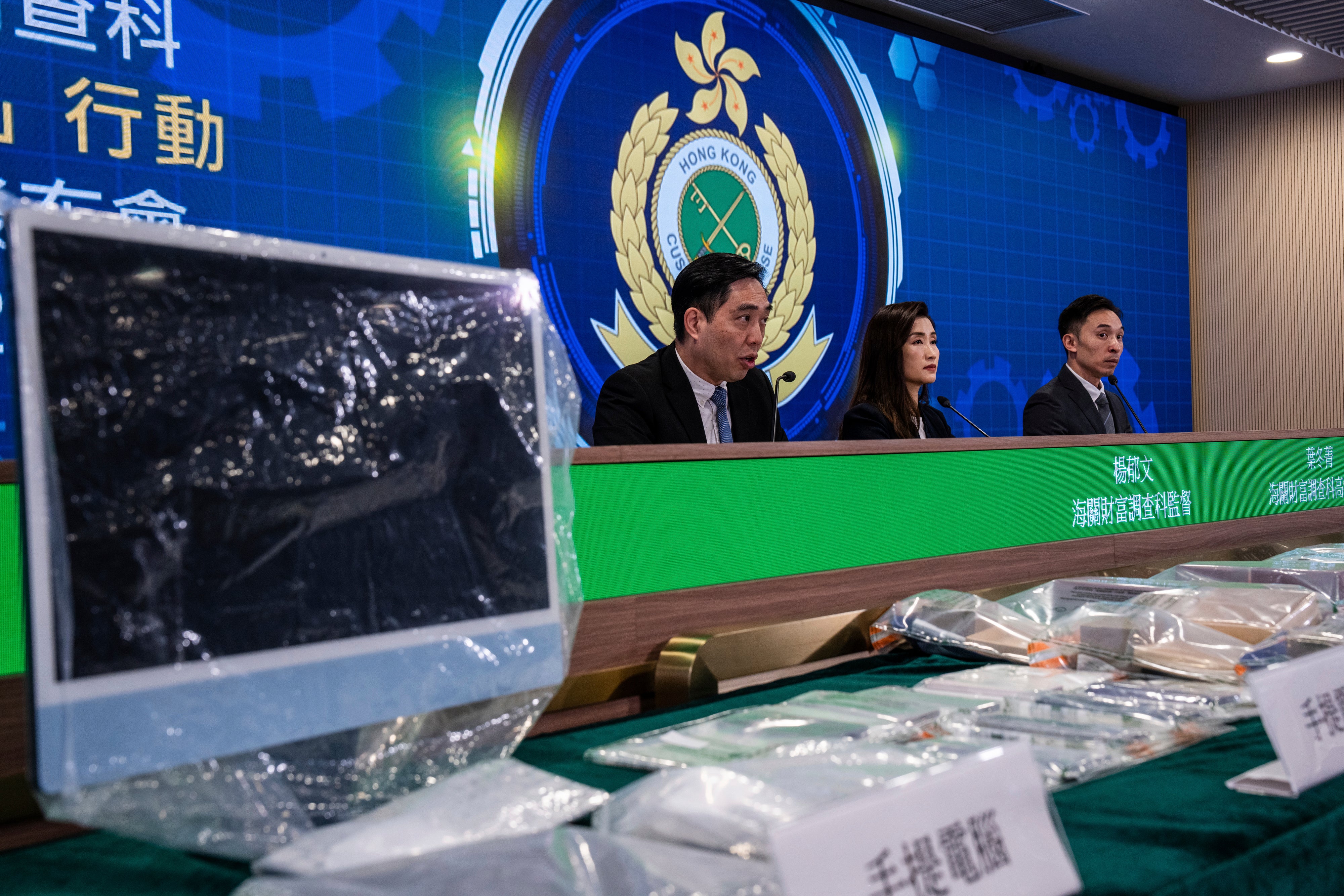 Deputy Head of Customs Financial Investigation Bureau Yeung Yuk-man, left, speaks during a press conference