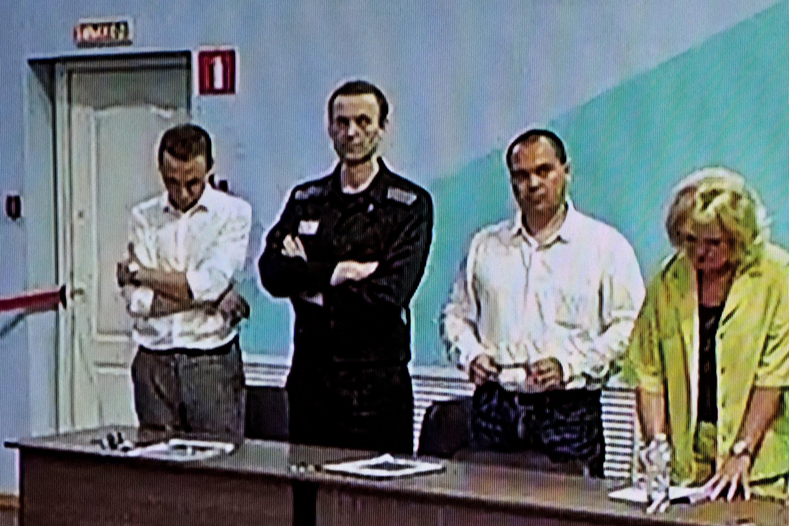 Navalny (second left) as he listens to his verdict over a series of extremism charges at the IK-6 penal colony