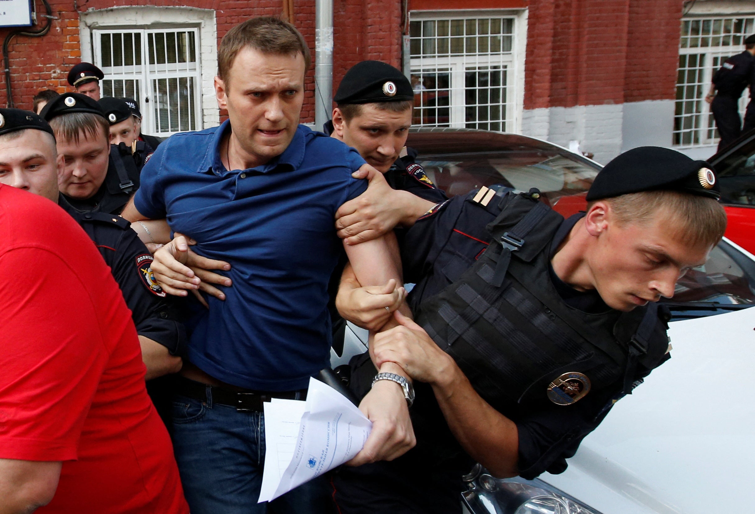 Police officers detain Navalny after he registered as a mayoral election candidate in July 2013