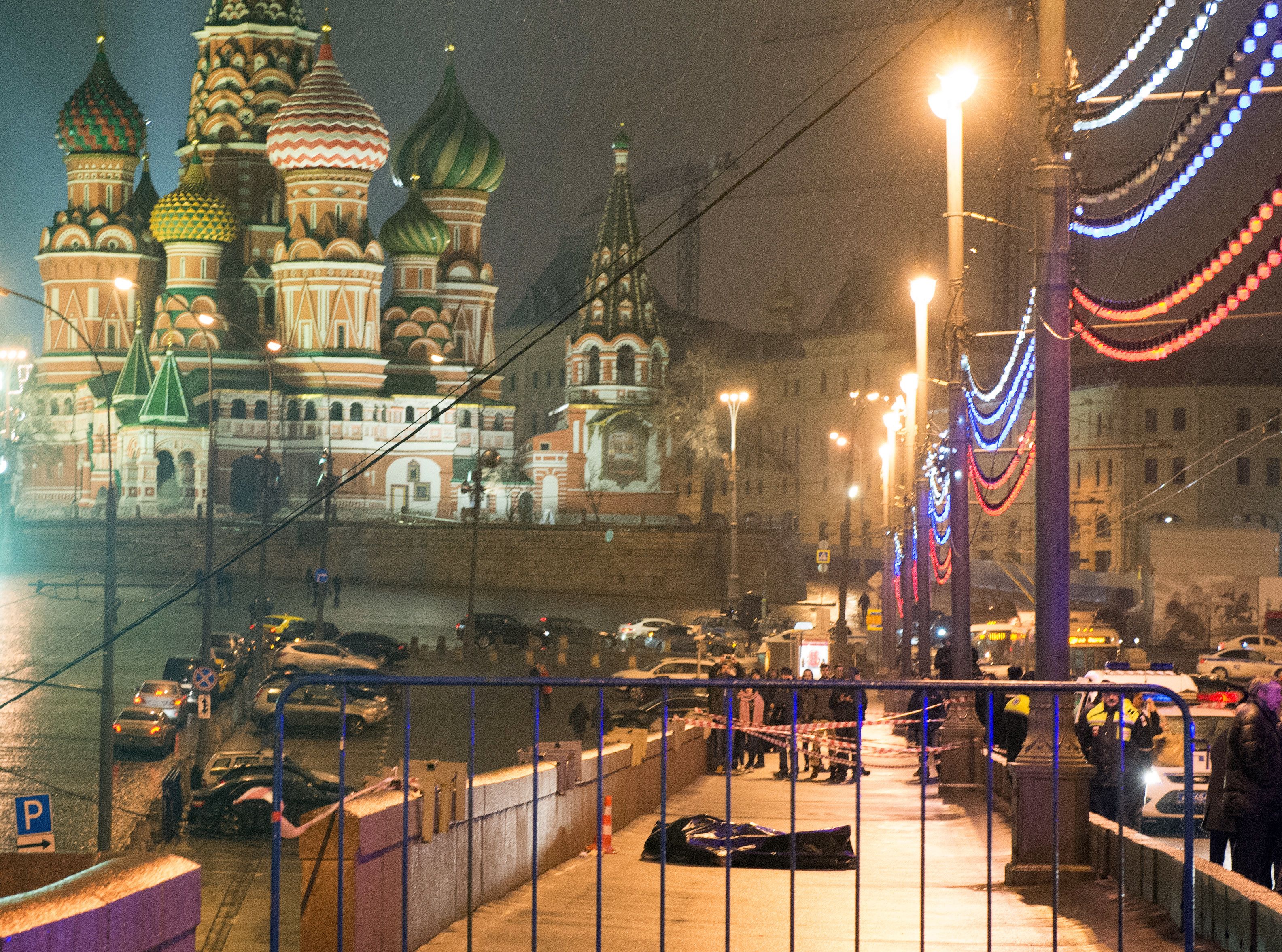 The body of Russian opposition leader Boris Nemtsov was covered with plastic after he was shot four times in the back on the Moskvoretsky bridge near the St Basil Cathedral in central Moscow on February 28, 2015