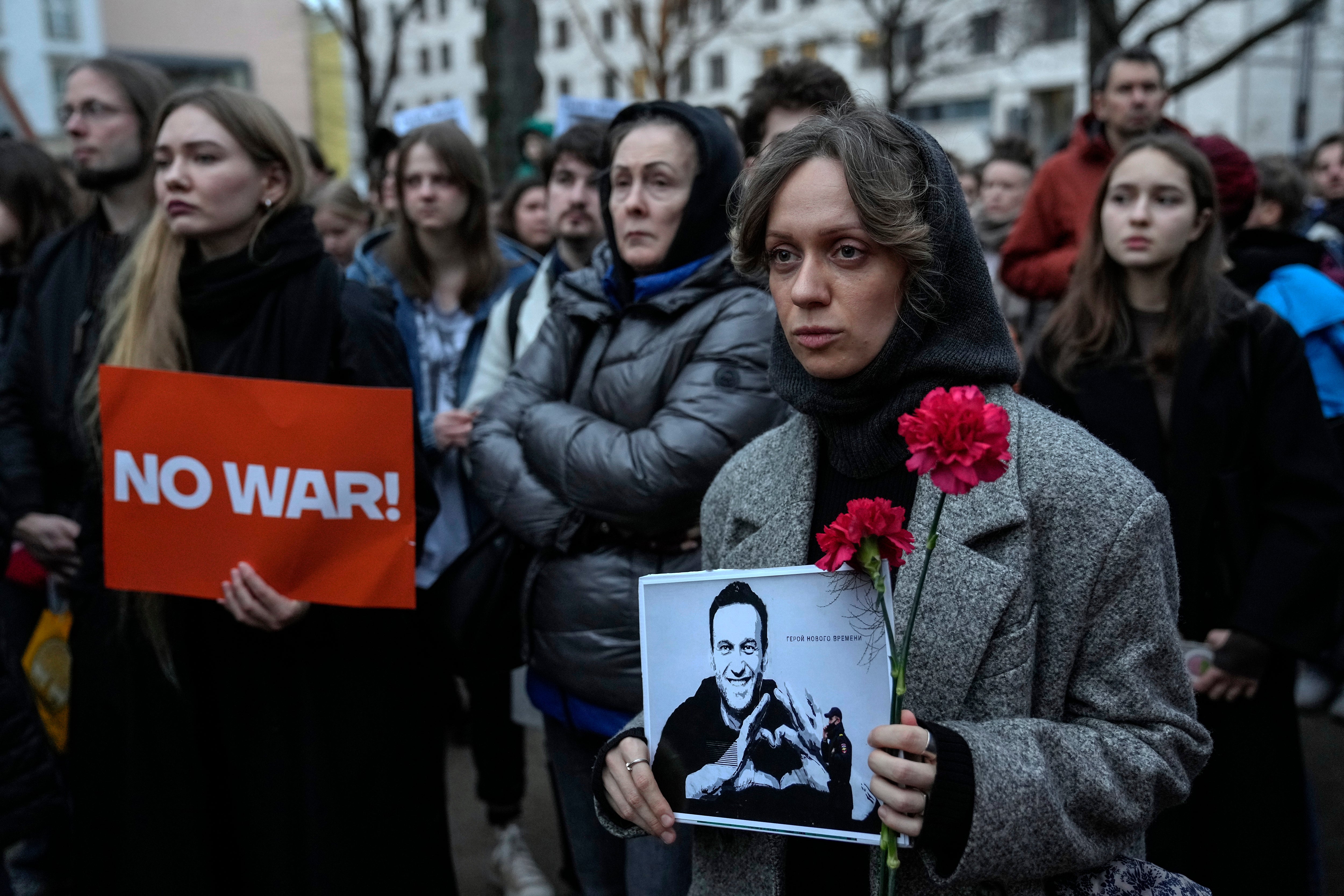 A woman holds a portrait of jailed Russian opposition leader Alexei Navalny during a protest in front of the Russian embassy